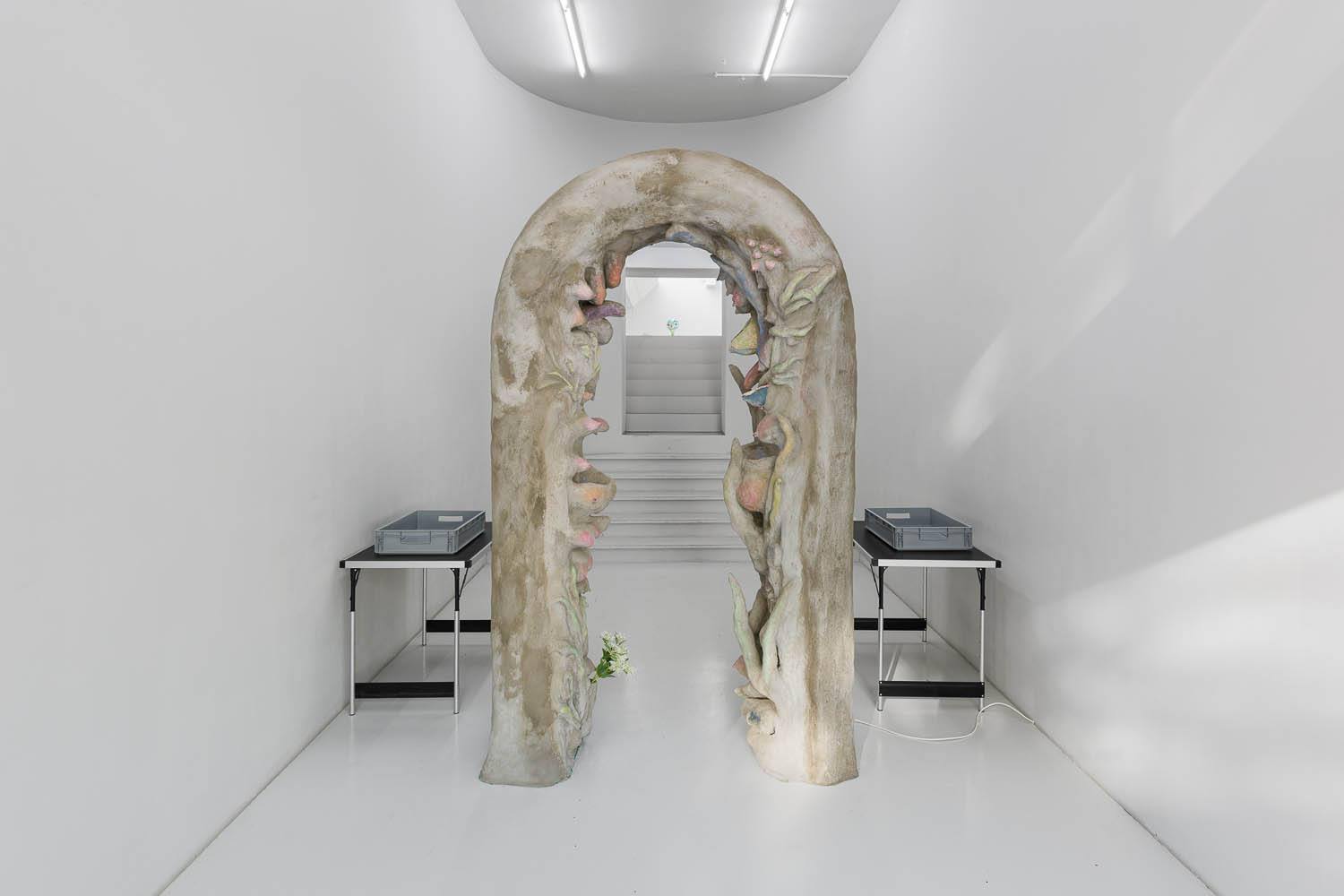 Laure Prouvost, Security Gate, 2019, wood and metal construction with concrete surface, acrylic, tapestry, motion sensor with sound, 250 x 135 x 45 cm, unique