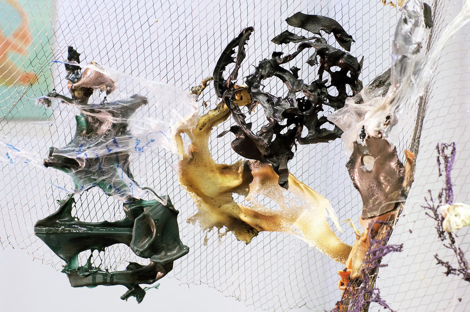 The installation consists of fused into a single layer photographs  of “natural” landscapes and plastics found at the shooting sites.