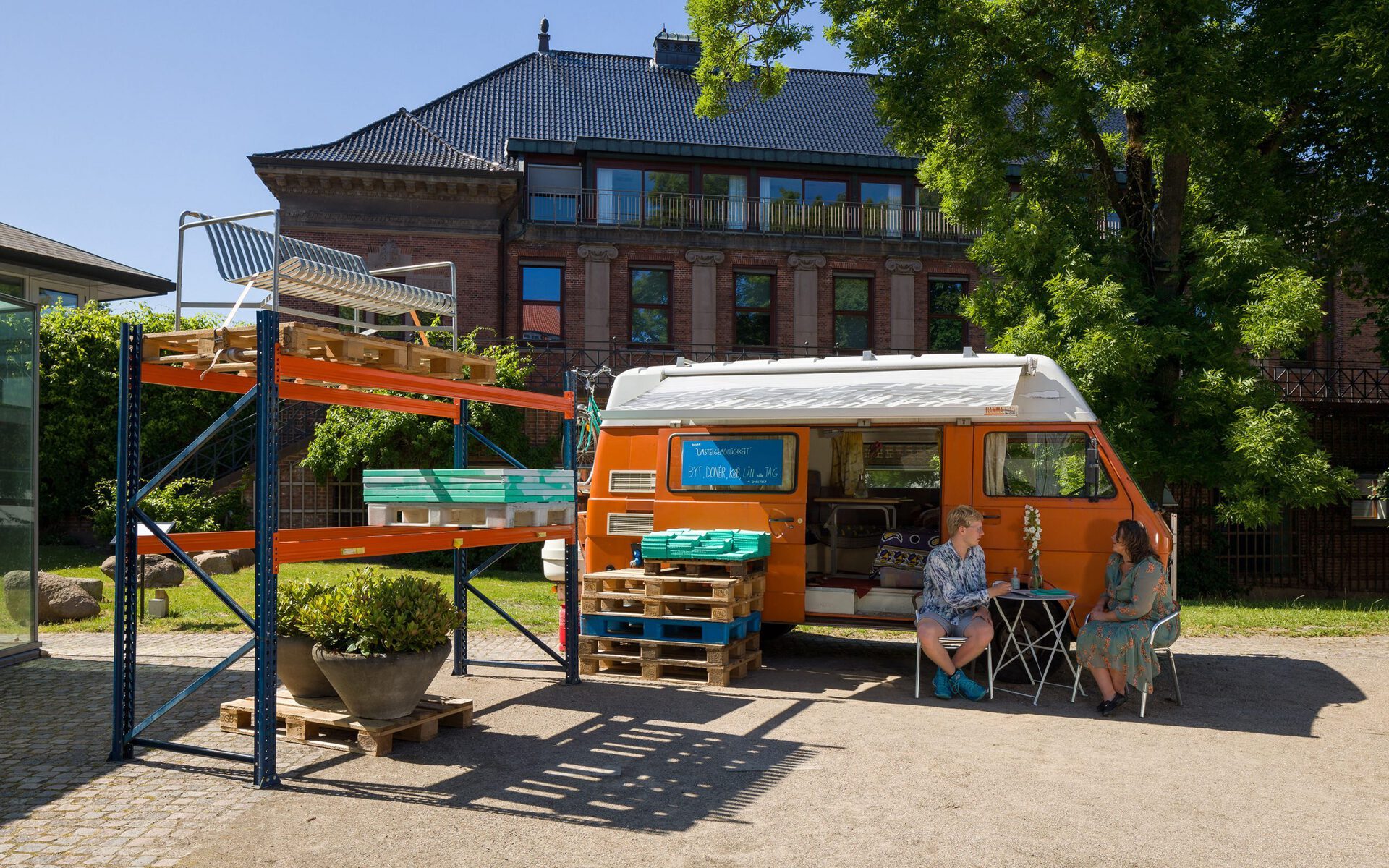 Villiam Miklos Andersen, Umsteigemöglichkeit, 2020, exhibition view w/ Andersen's Studio Van and pallet racking with exhibition objects, Kunsthal Aarhus, photo: Mikkel Kaldal