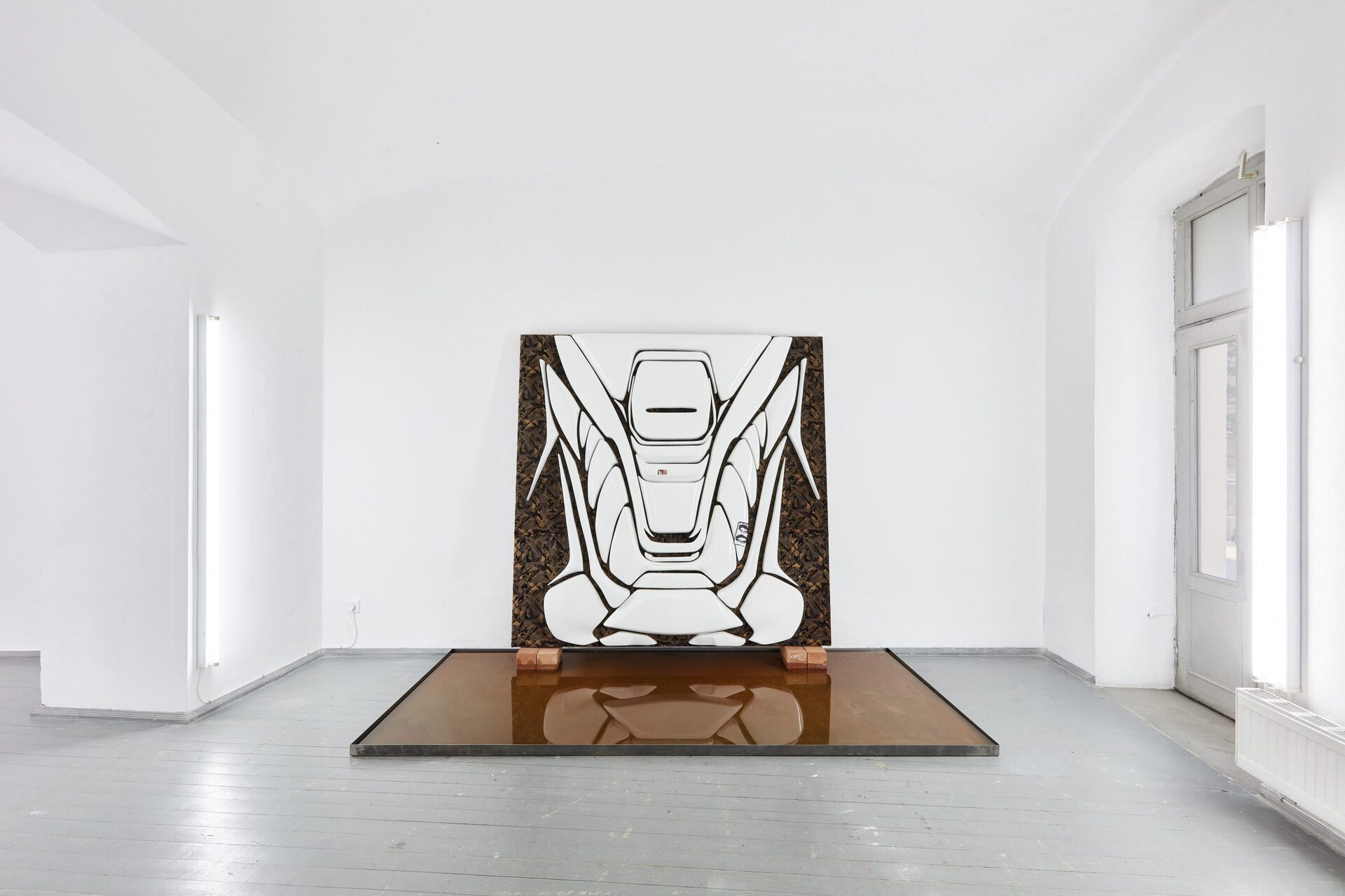 Adrian Kiss, Untitled (Durva kocsi), 2020, Polystyrene foam, tile adhesive, polyurea resin, household paint, automotive fabric and paper on wooden panel with metal plate, bricks and water, 290 x 140 x 213 cm