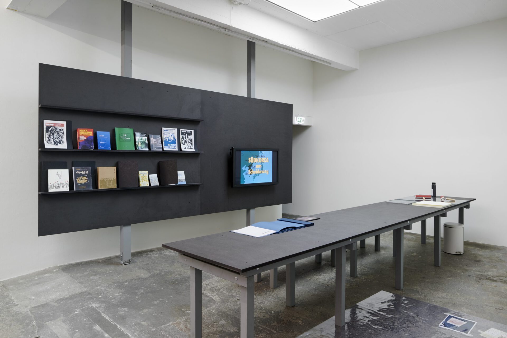 Christian Nyampeta, A Dedication to the People´s Art School, workstation with printing tools, books, references, curtain, 2020, Akademie der Künste der Welt (Academy of the Arts of the World, ADKDW)