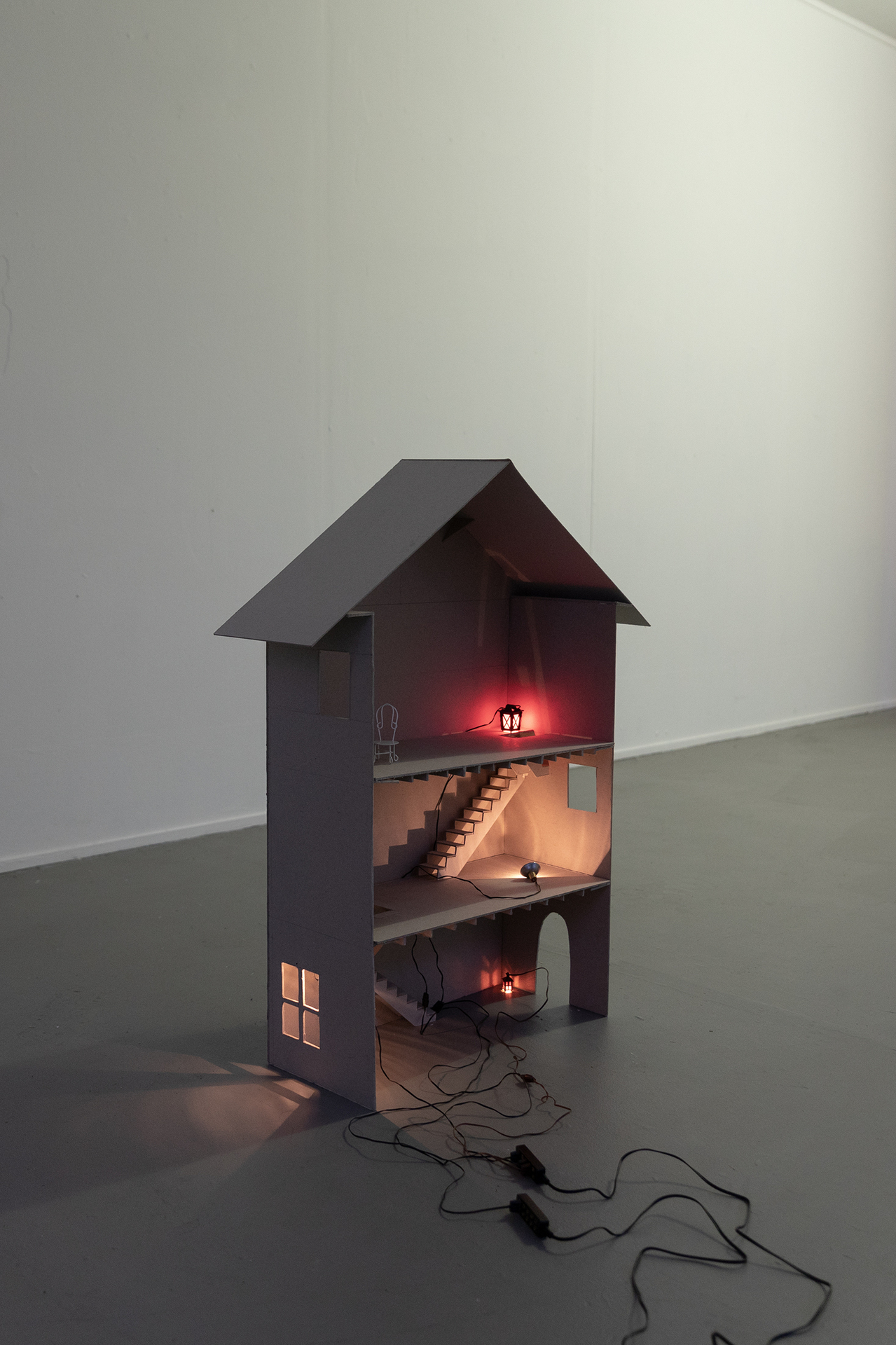 Giovanna Belossi & Francesco De Bernardi, Where it all happens Those tender moments Under this roof, 2020, cardboard, glue, lights, electronic elements, toy chair, 90x66x20 cm