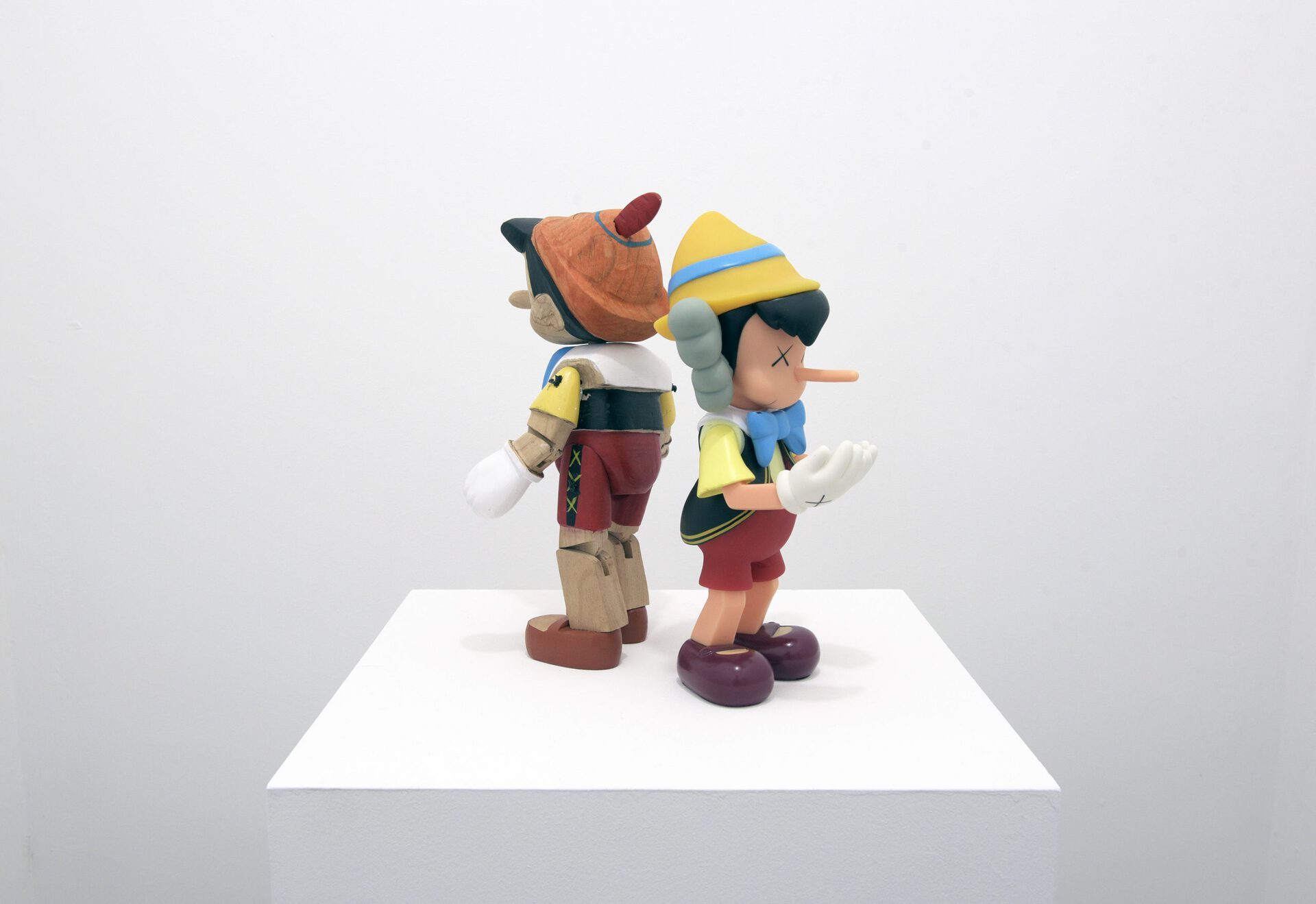 Marek Wolfryd, I think I see you brother but the mist is thick 2020 KAWS vinyl Pinocchio collectable toy and wood Pinocchio puppet by unknown artist 29 x 29 x 17 cm.