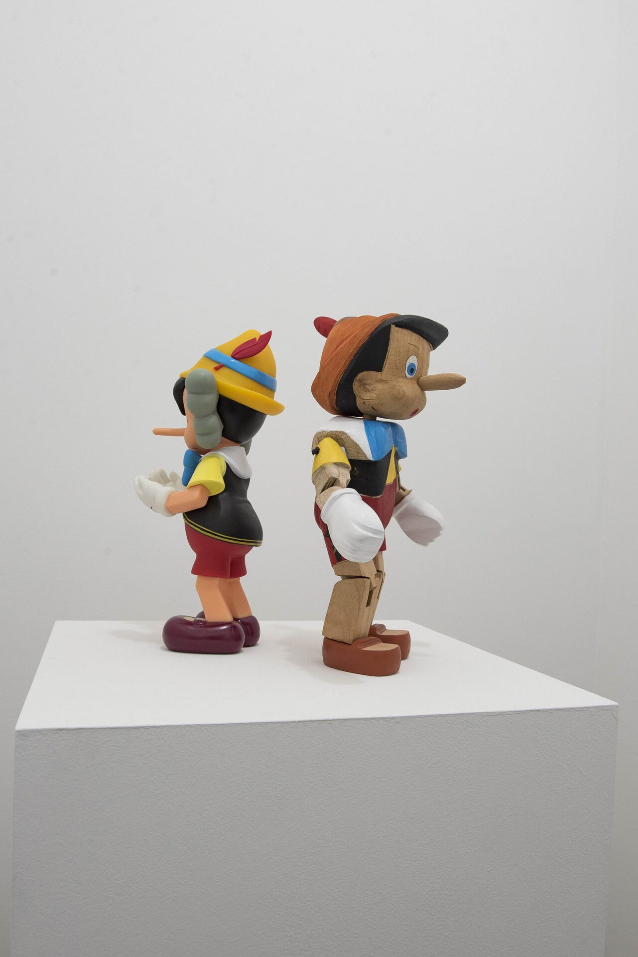 Marek Wolfryd, I think I see you brother but the mist is thick 2020 KAWS vinyl Pinocchio collectable toy and wood Pinocchio puppet by unknown artist 29 x 29 x 17 cm.