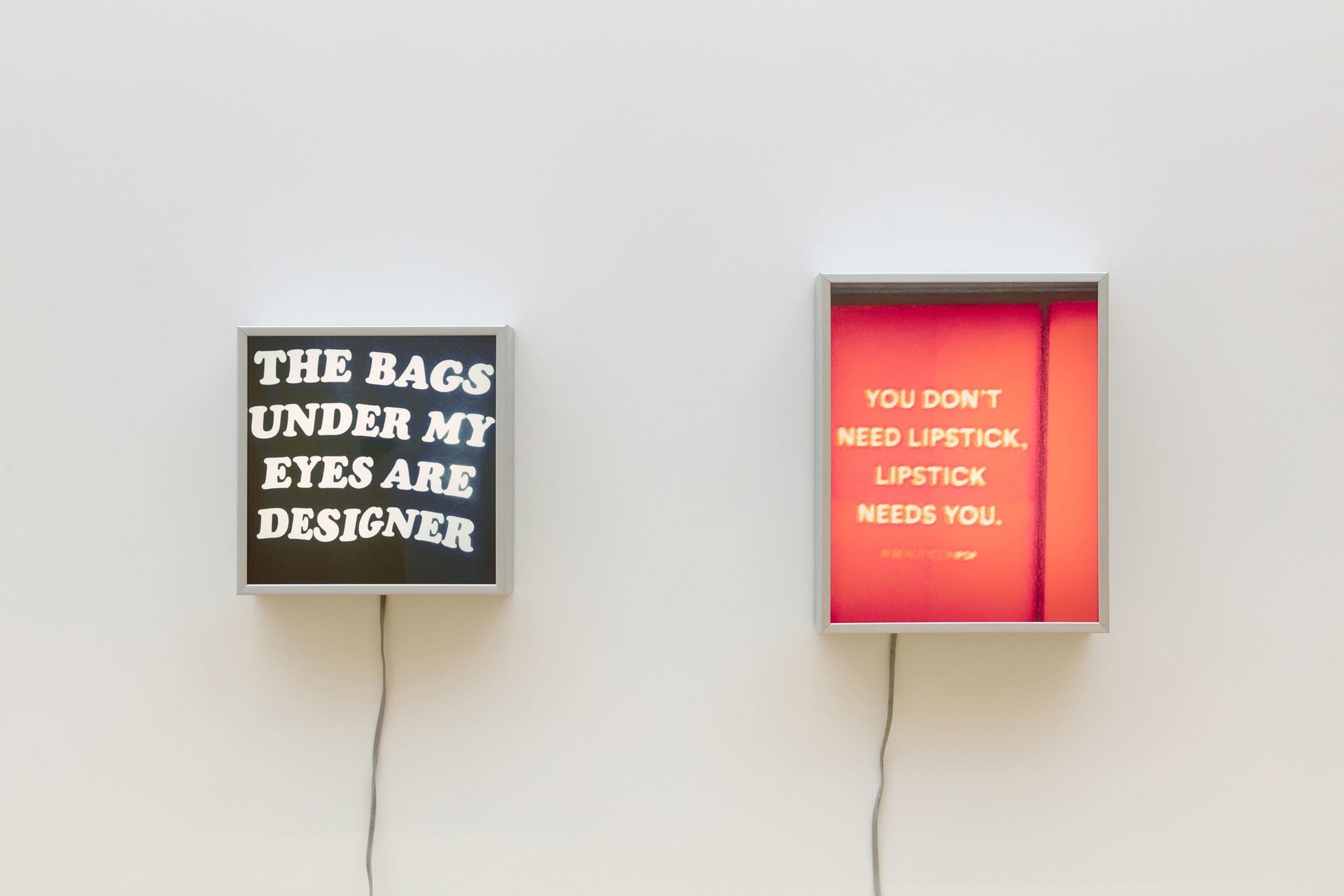 Ellen Schafer, Left: Shiny Happy People (Laughing) (The bags under my eyes are designer), 2020, Illuminated sign, digital print on backlit film, 15.5 x 15.5 inches; Right: Shiny Happy People (Laughing) (You don't need lipstick, lipstick needs you), 2020, Illuminated sign, digital print on backlit film, 21.5 x 16.5 inches.