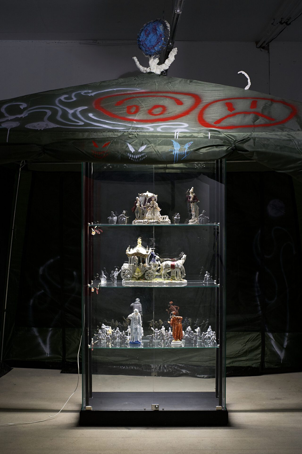 Vladimir Kartashov, the fragment of the show "Innocent pranks. Technorococo" - tent, porcelain of the XVIII century, small figurines by author, 2021, mixed media, cardboard, paintings, approx. 8 sq m.