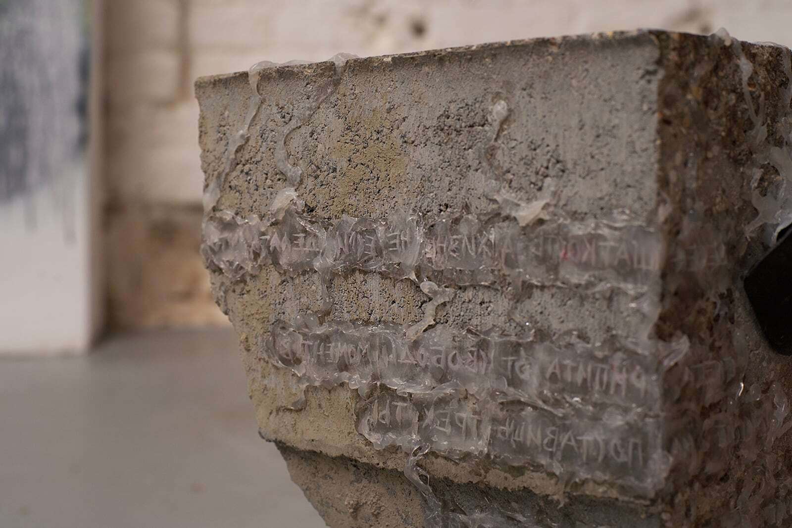 Daria Makarova, Il n'y a de cause que de ce qui cloche (detail), 2020, concrete, building sealant, dust, wrapped poetic text, food-grade silicone, orthopaedic chair wheel
