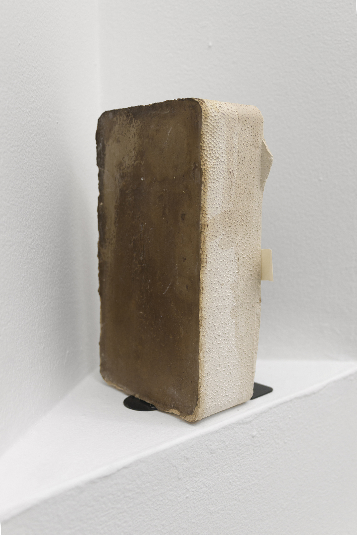 Justin Chance, Dictionary, 2020-2021, Black tea, plaster, sheetrock, carpenter's pencil, floor wax, book end, 5.5 x 4.5 x 10 in.