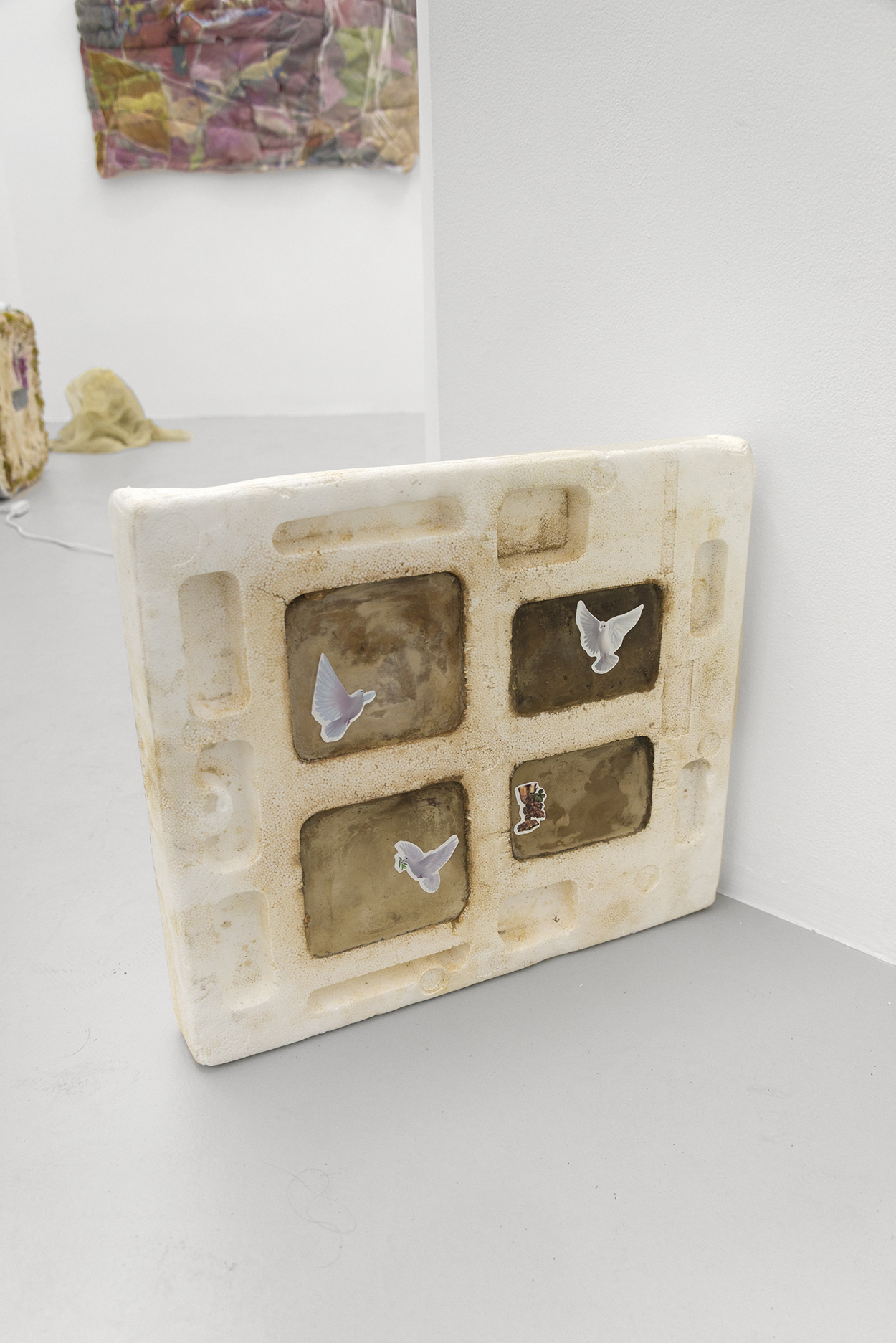 Justin Chance, Pentecost (White tea, black tea, green tea, gold tea), 2021, Black tea, gold tea, green tea, white tea, plaster, shipping styrofoam, sealing wax, stickers, 24 x 22 x 3.5 in.