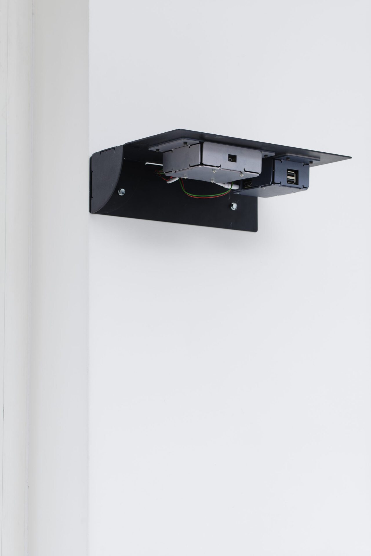 Christophe Lemaitre and Kim Farkas, Untitled, 2017. Folded and pierced aluminum plate, electronic card, artificial neural network, charger, battery, daylight sensor, diodes, connectors, 21 x 30 x 9 cm