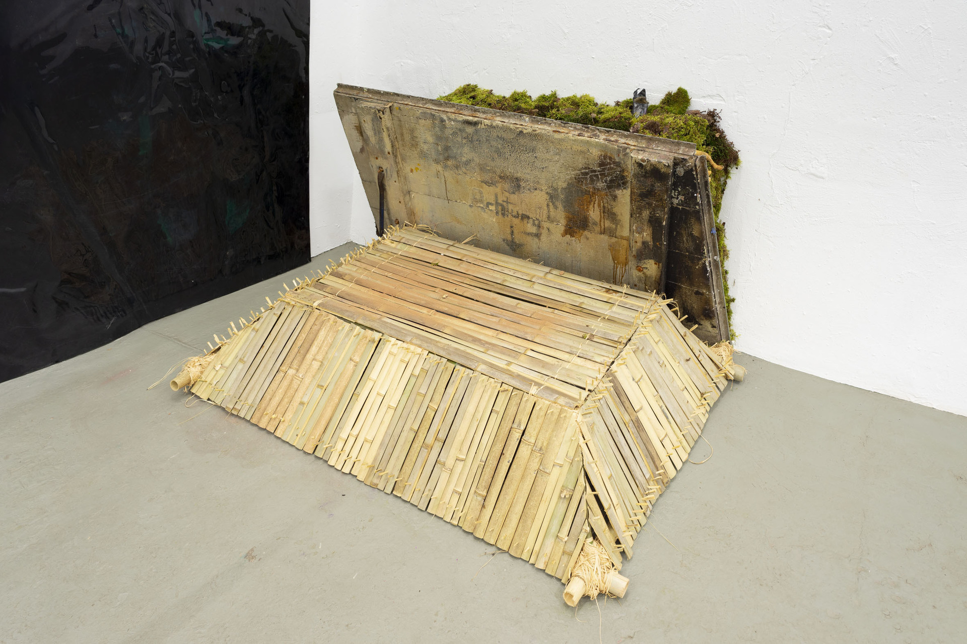Edgar Unger, descent into Limbo, 2021, bamboo, moss, found objects, slime, trapdoor