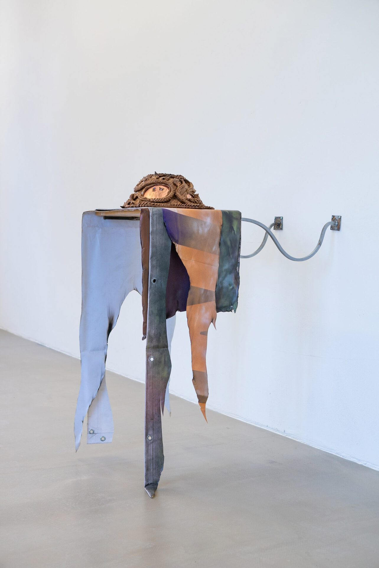 Anastasia Sosunova, Passage pie, 2021. Rye flour, saline, salt, epoxy resin, copper, stickers, spray paint, vinyl banner