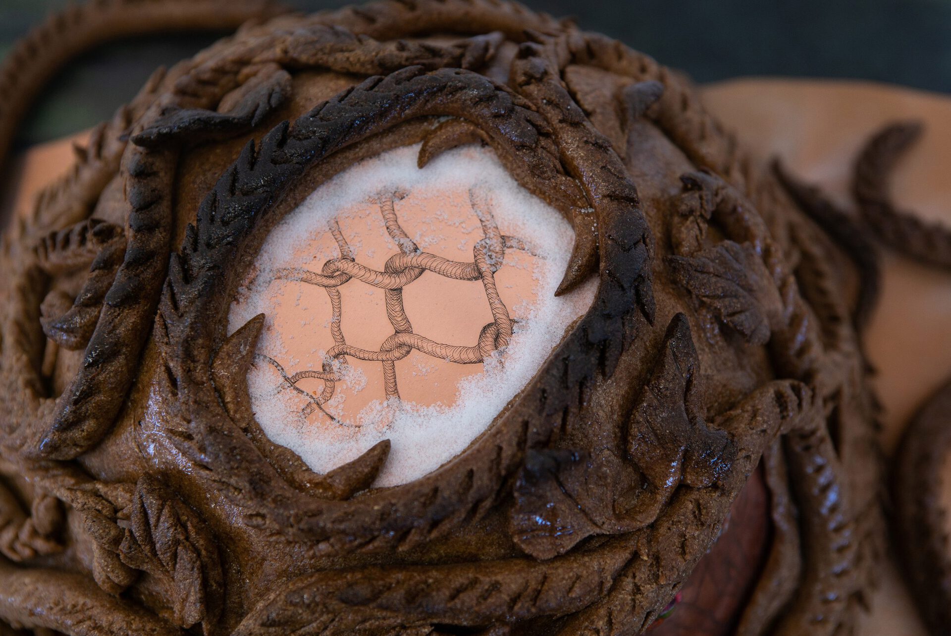 Anastasia Sosunova, Passage pie, 2021 (detail). Rye flour, saline, salt, epoxy resin, copper, stickers, spray paint, vinyl banner