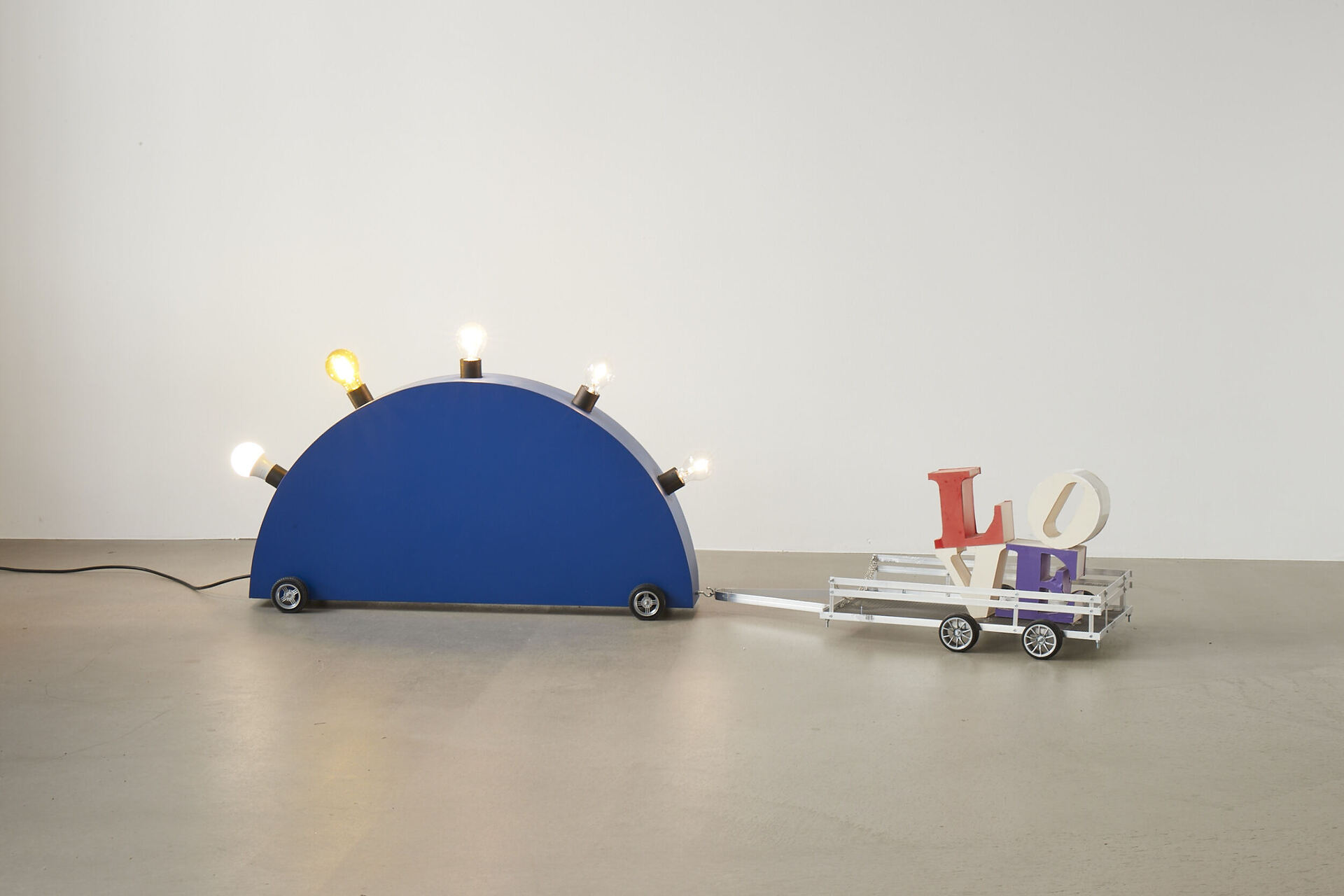 Frieder Haller, Memphis Blues (after Martine Bedin) IV, 2021 Wood, wire, board, electrical wiring, two light bulbs and model car wheels 51 × 158 × 33 cm / 20 × 62.2 × 12.9 inches