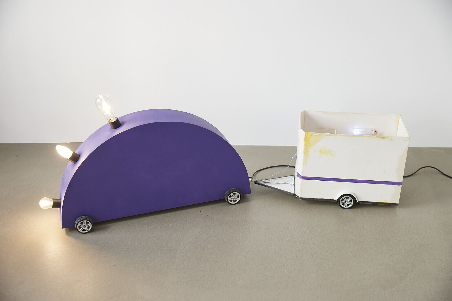 Frieder Haller, Memphis Blues (after Martine Bedin) II, 2021 Wood, wire, board, electrical wiring, two light bulbs and model car wheels 53 × 146,3 × 23 cm / 20.8 × 57.5 × 9 inches
