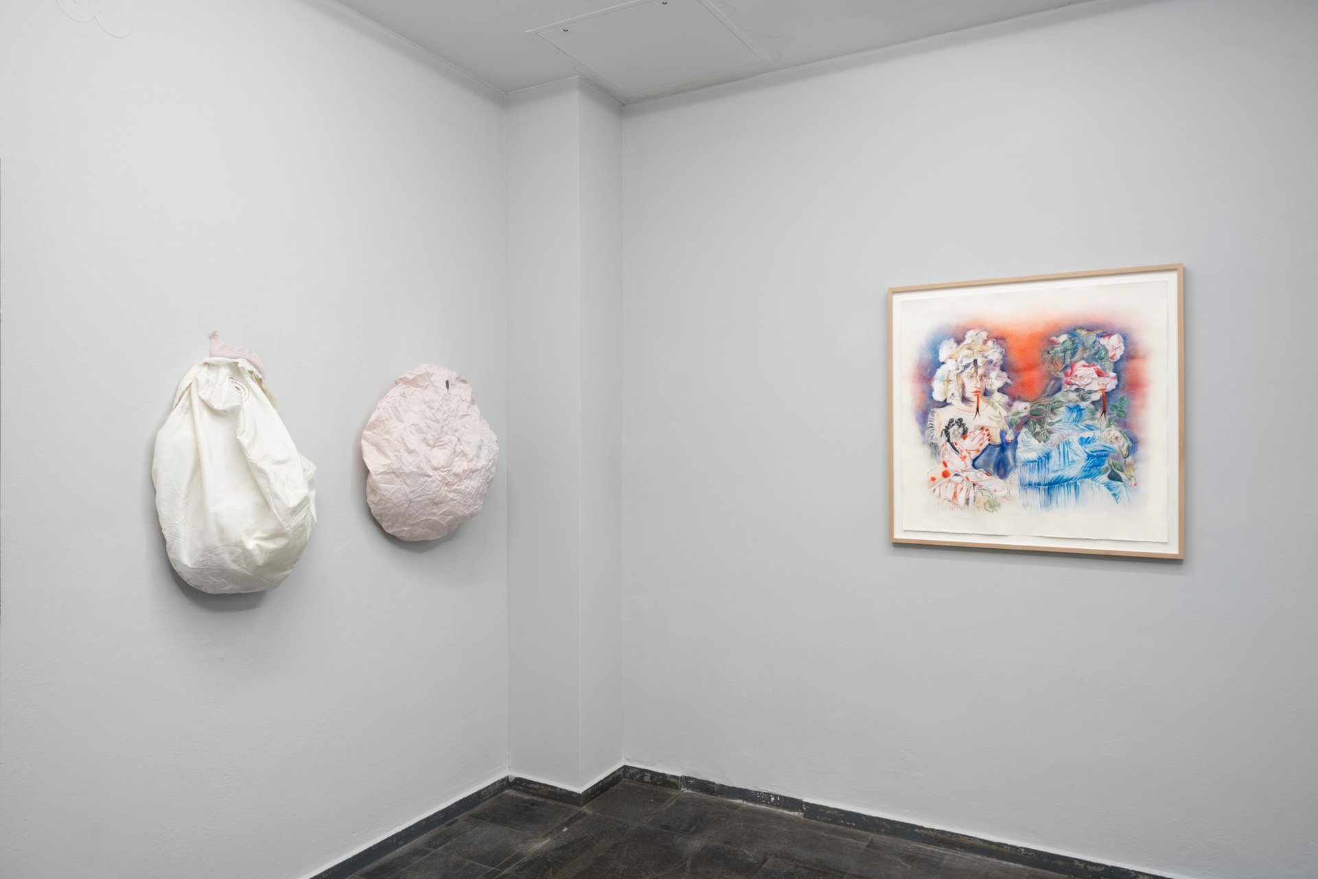 From left to right:   ALANA LAKE, Crash, 2021
Used car airbags, dimensions vary  (from the involuntary sculpture series)  2 in total, 1 white, 1 pink  MARIANNA IGNATAKI, The Great Lick, 2021 Watercolor, gouache, color pigments, graphite and colored pencils on paper 80x80cm