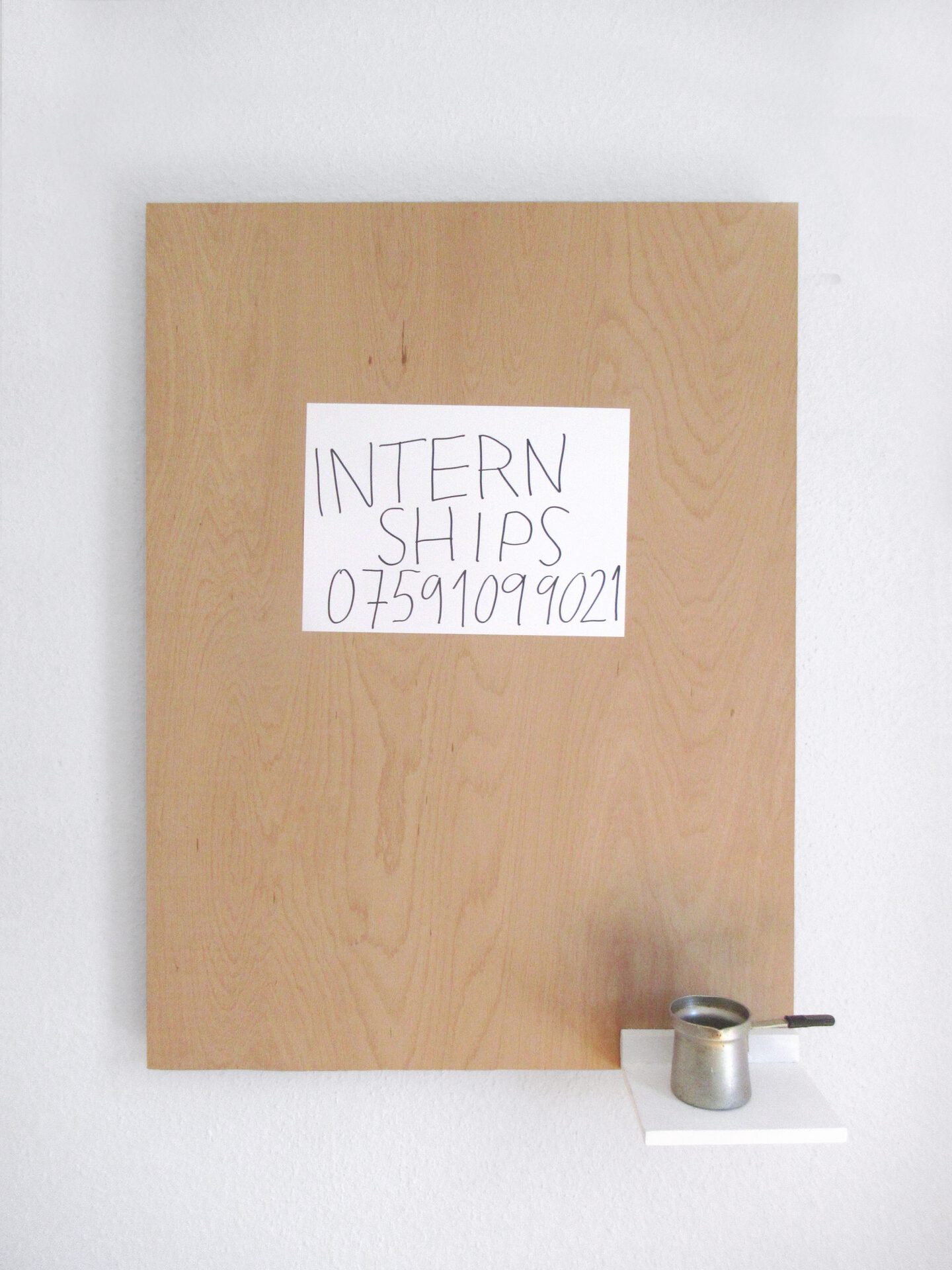 Ariel Helyes, Interns’ call (coffee version) 2021 wood, coffee, metalic bowl, artist’s phone number, aluminium harware, paper 80x60x6 cm