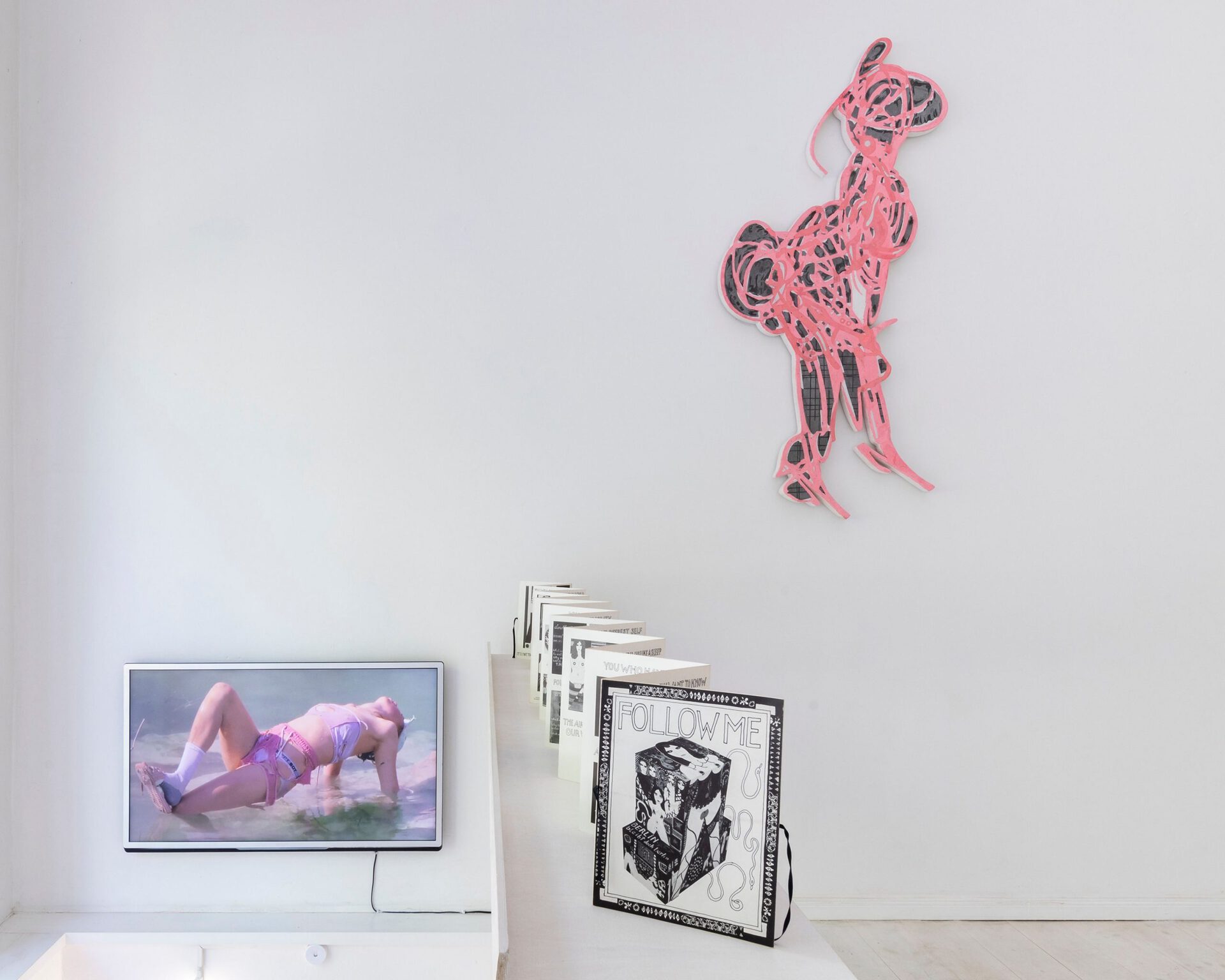 Video: Young Boy Dancing Group, 2021, HD, Loop, 3:44 min / Wall: Caroline Eidner, Untitled (Lady T-Rex), 2019, pigmented plaster, mounted on styrofoam, wood, 155 × 65 cm / Artist Book: Dorothy Iannone, Follow Me, 1978