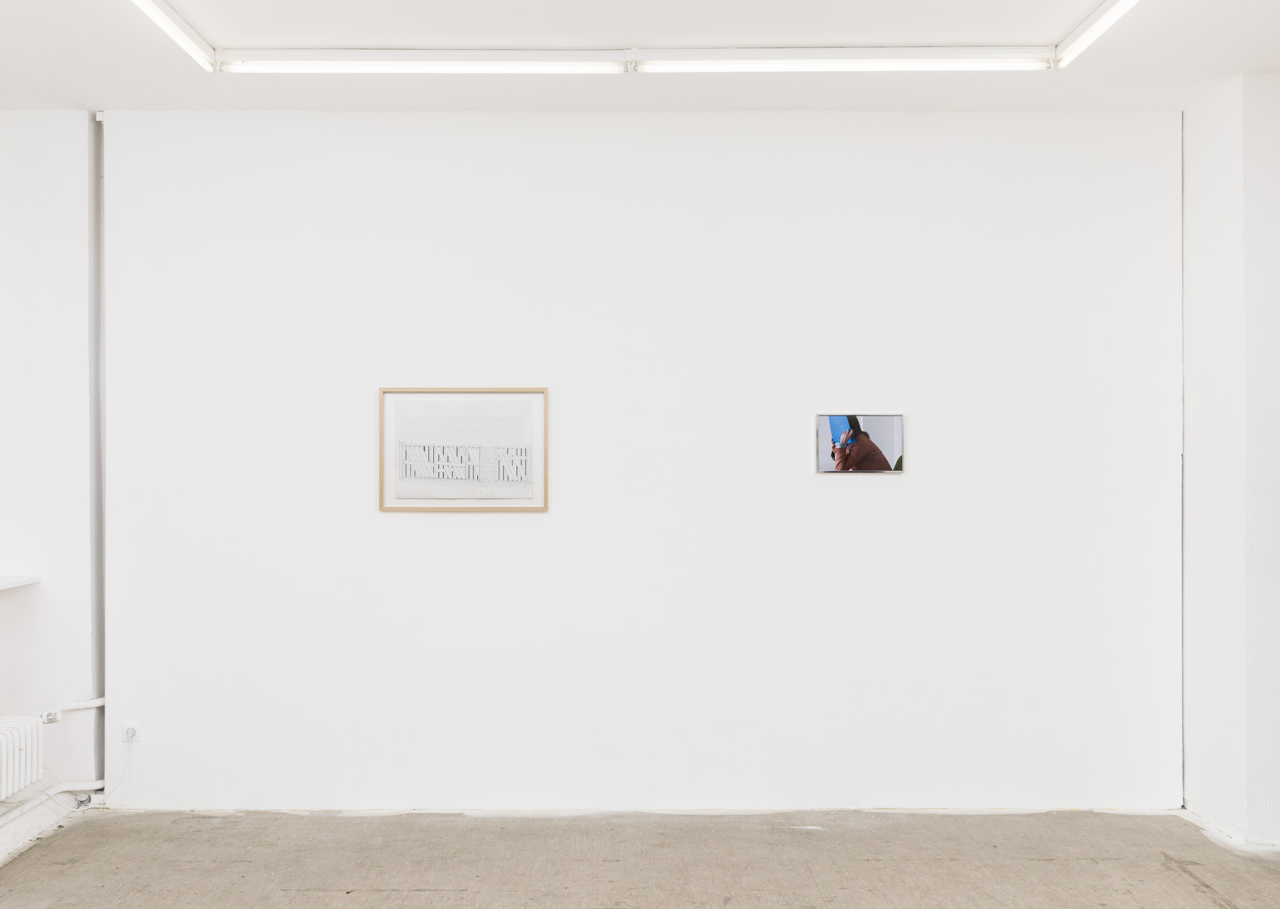 Installation view with: James Sturkey, Untitled, 2019, pen and correction fluid on paper, 72,5x52,5cm; Anna Ruthenberg, Untitled, 2020-2021, series of photographs, 25x37cm.