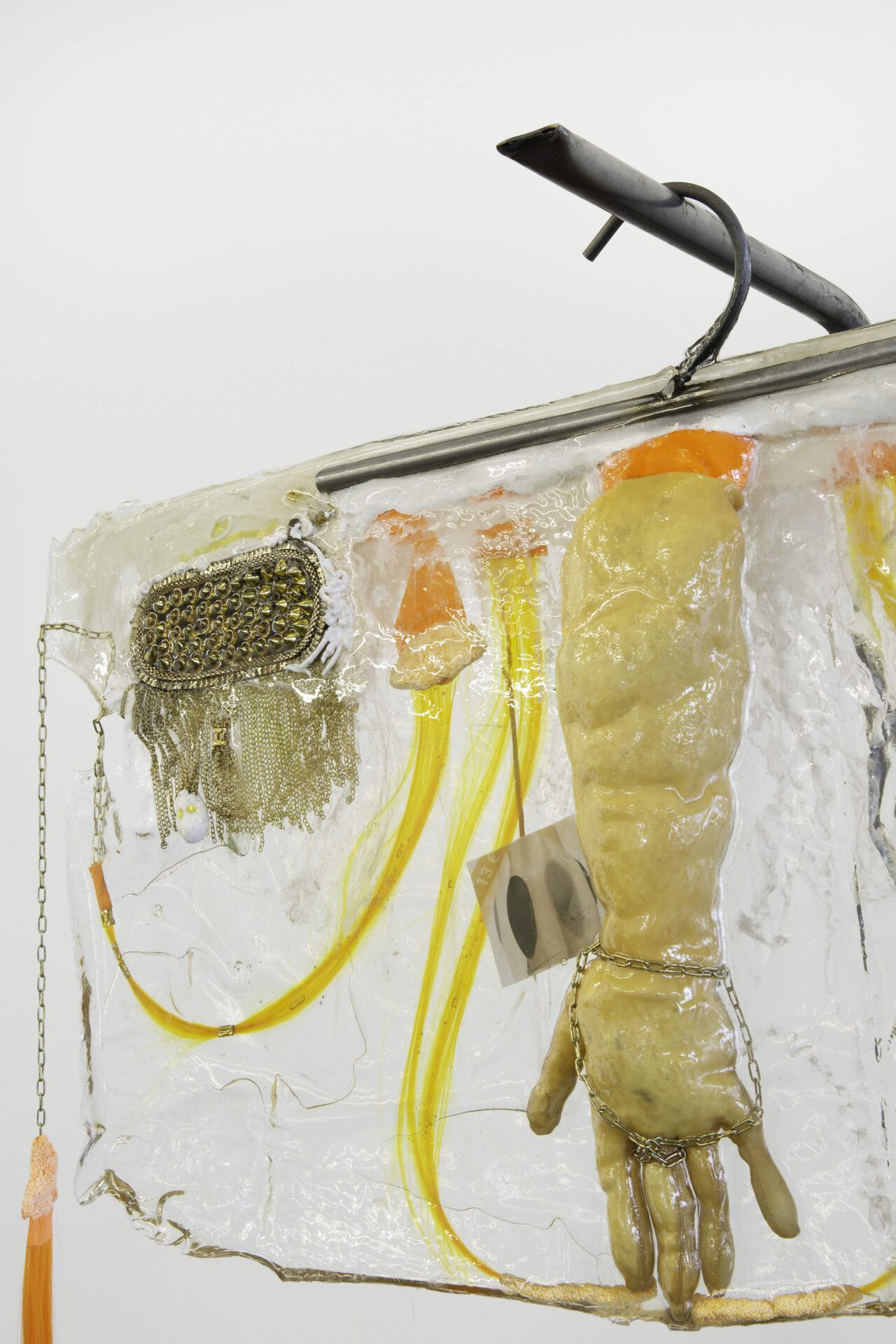 Theresa Weber, Detail of Glove, 2020, glove, synthetic hair, modeling clay, tape, chain, prints on paper, rivets, pigment in polyester on metal