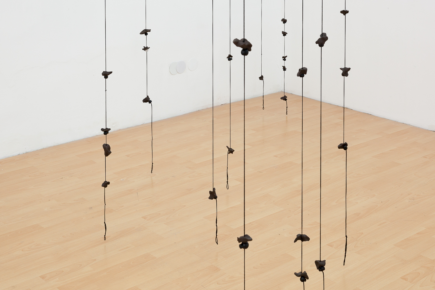 Jan Erbelding, Alphabet /Rings of Saturn, 2021, ceramics, Polyester cord, cord stoppers, variable dimensions