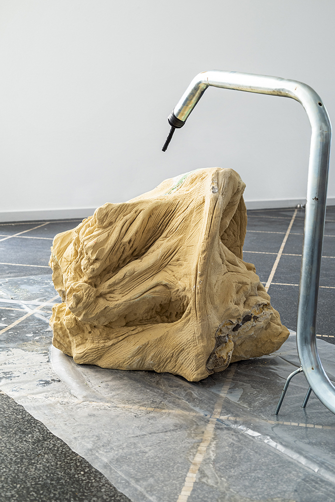 Nina Nowak  A Timeline starting on the Surface. The Material World Pt. 2, detail, 2021,  carved marl sandstone, plastic foil, galvanised steel, copper oxide, dirt, water, vulcanising tape, hose Dimensions variable.