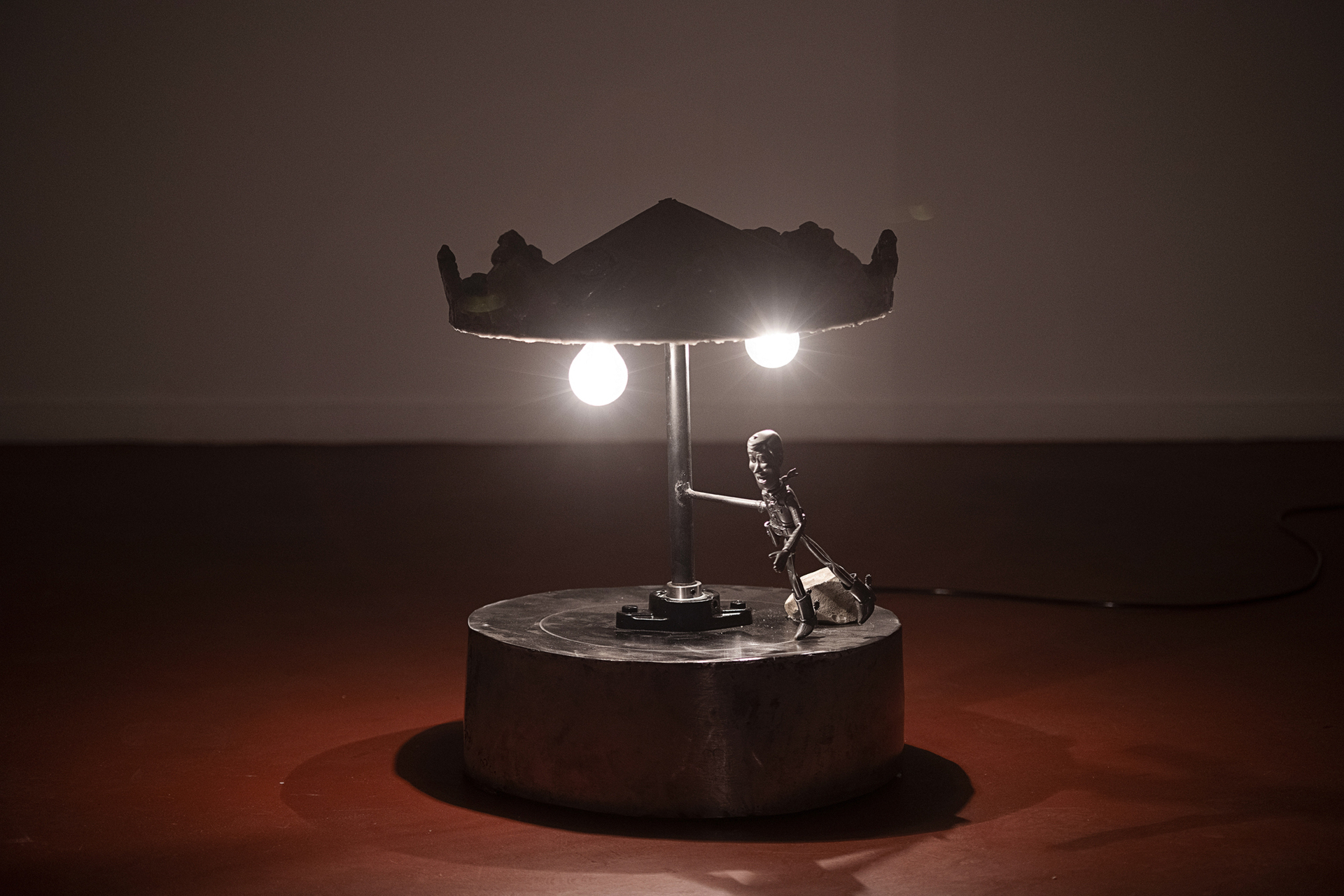 carousel, 2021 iron, resin, figure, halogen lamp, synchronous motor 36 x 56 x 36 cm