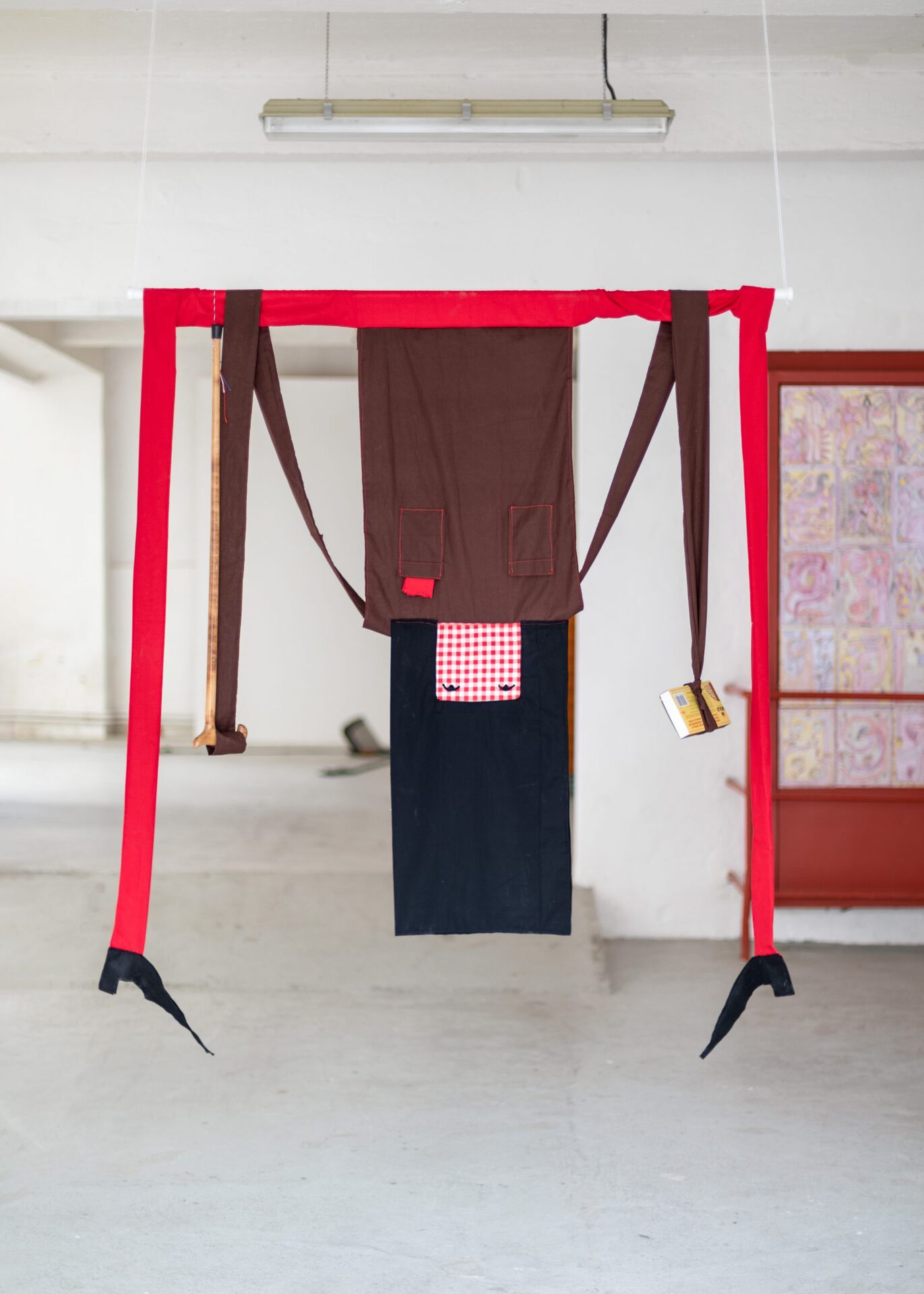 Girl With Matches and Walking Stick, 2021, fabric, felt, matches, walking stick, pole 140 x 150 x 20 cm