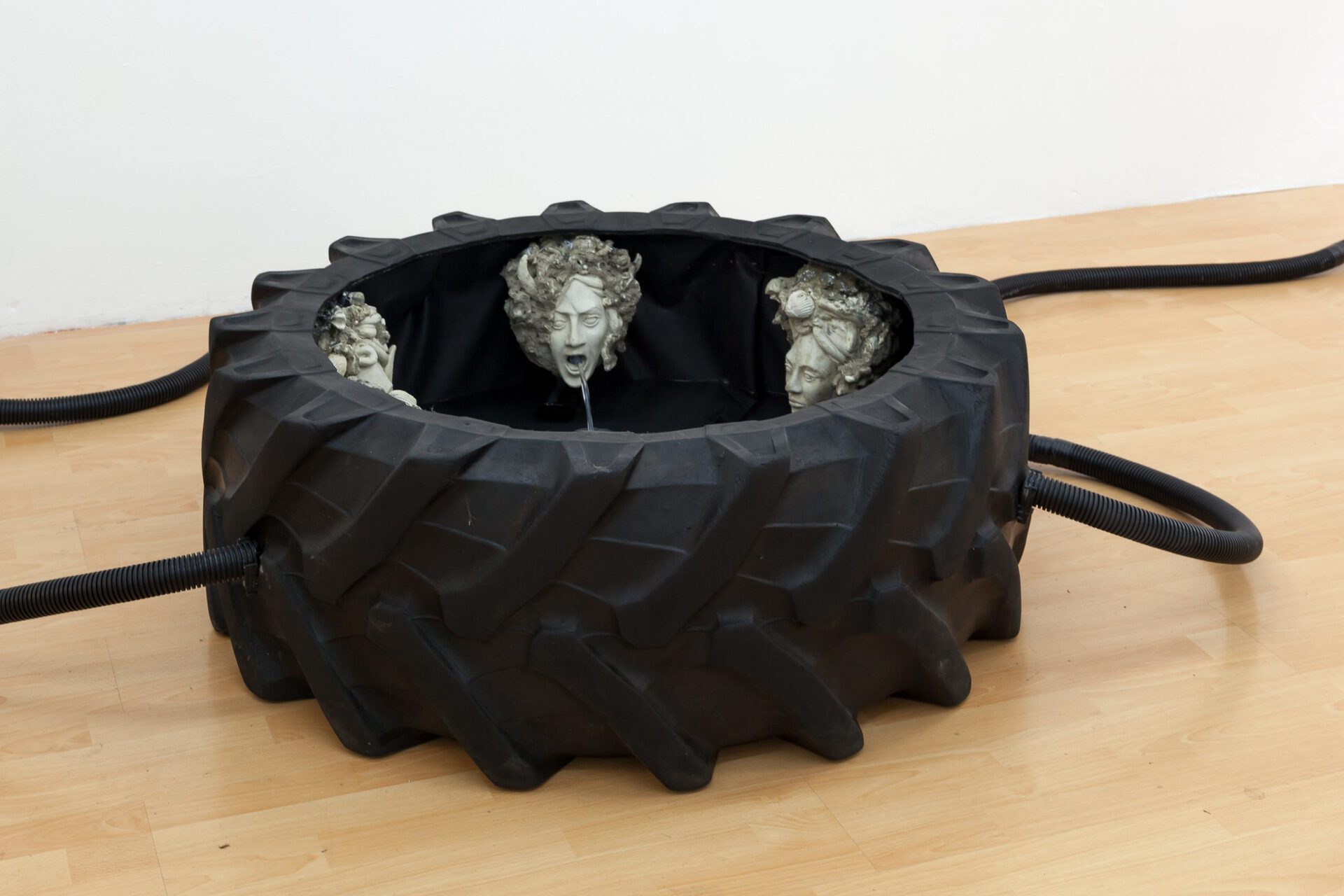 Absolution, 40 x 100 x 100 cm,  tractor tire, cast stone, water, pvc, 2021