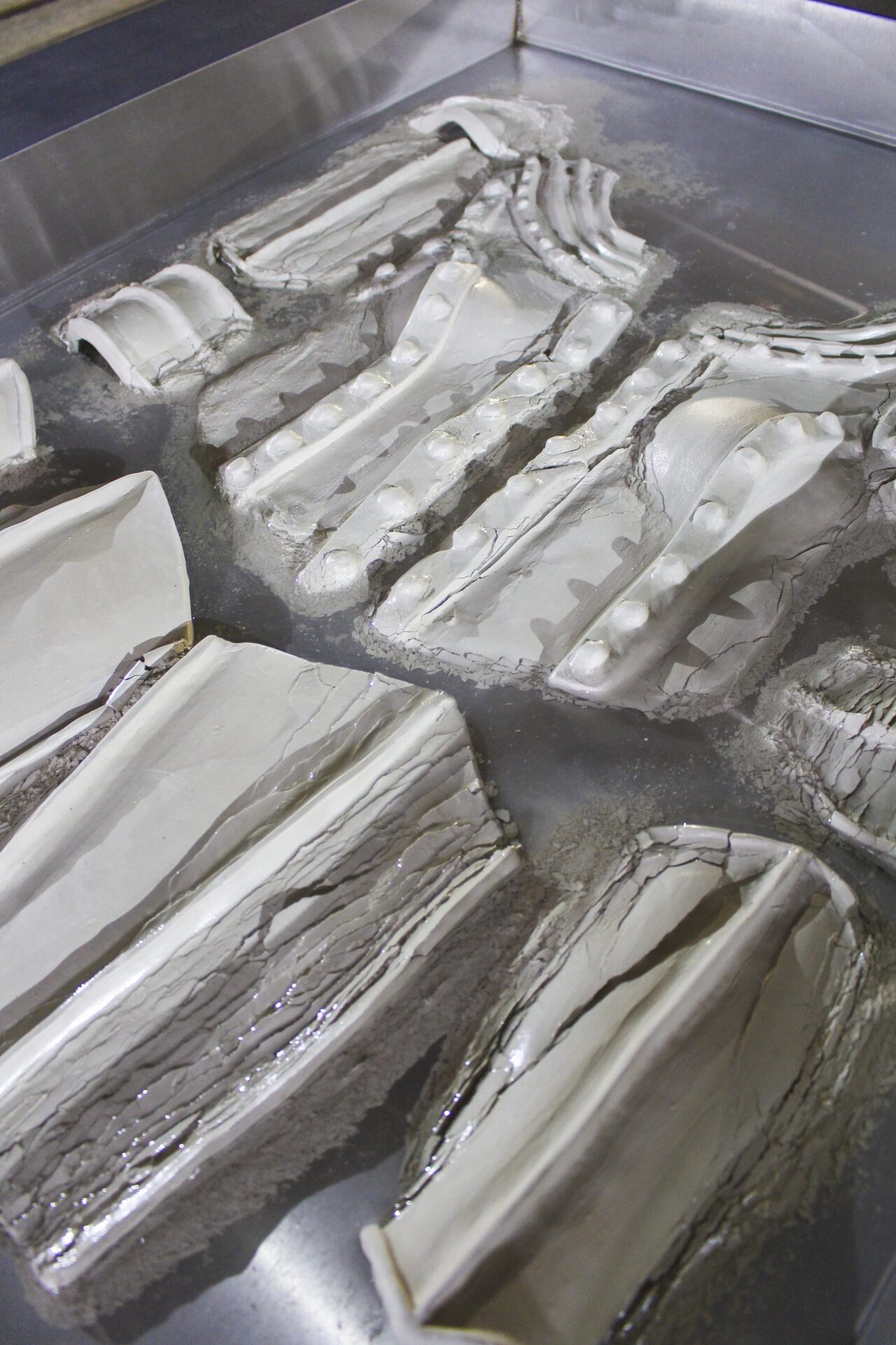 Keegan Luttrell, Membrane (detail), 2021, dims variable, unfired clay, stainless steel, MDF, water.