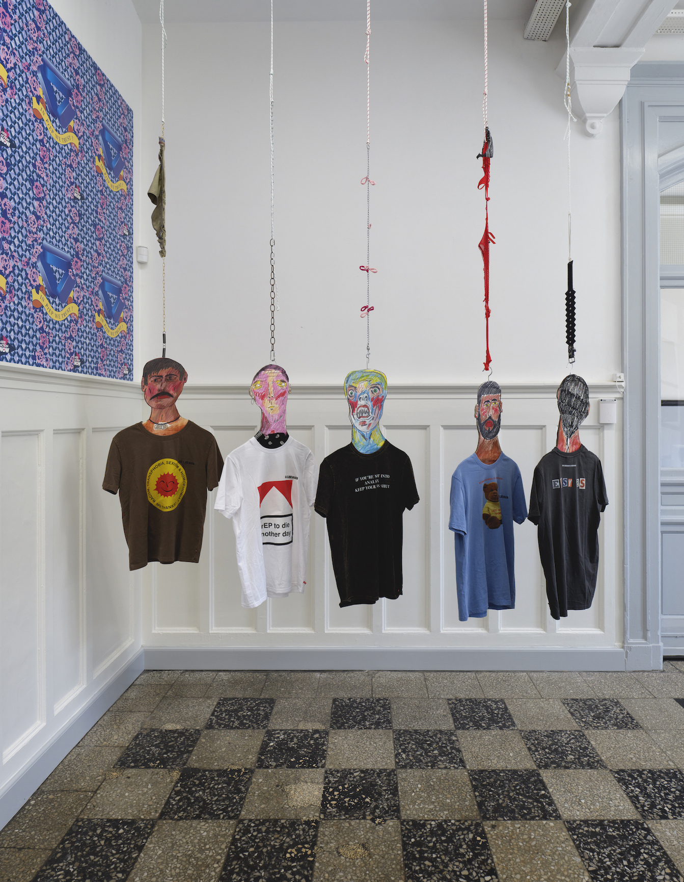 left: Brendan Fernandes: IN PreP WE TRUST?, 2016. Posters. right: Karim Boumijimar: Flat Daddies, 2021. Cardboard, oil stick etc. & Filip Berg, ©T-estimony, Han Kjøbenhavn, O—Overgaden: HEN, 2021. T-shirts, print.