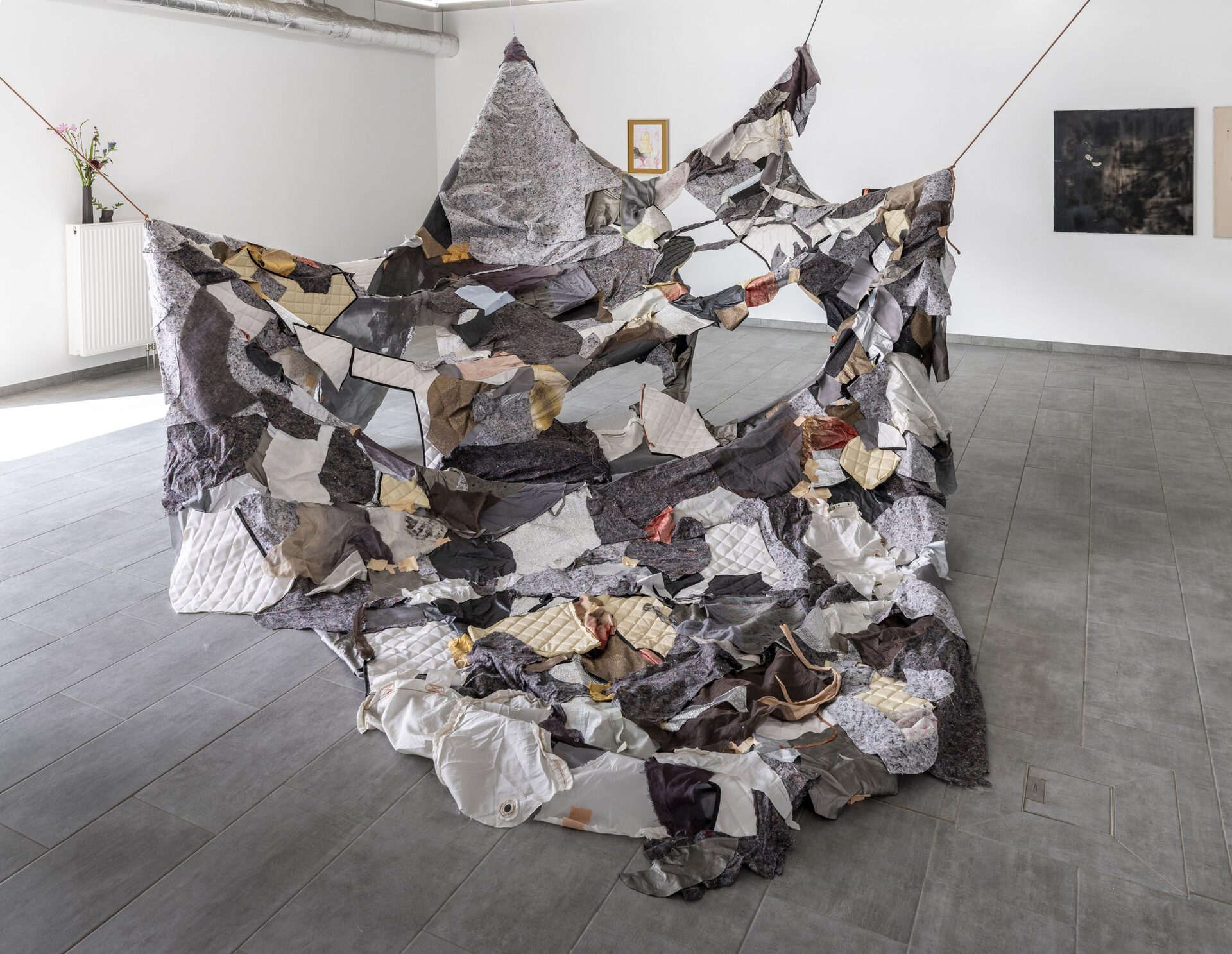 Group Show, Public Relations, 2021, installation view, STUDIO PERAGINE in front: Alice Peragine Soft Roader, 2021 car tarpaulin for SUV from the performance Soft Roader, painter's fleece, airbag, truck tarpaulin, sleeping mat film, silk, linen, velvet, imitation leather, imitation asphalt, kinesio tape, approx. 390 x 600 x 240 cm Photo: Helge Mundt