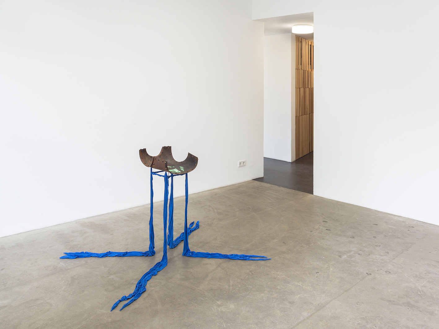 Mara Wohnhaas, “Table Top”, 2021 Antique piece of metal back armor, steel, fabric, fabric stiff, gel stickers, antique ring, chain, fishing weights, 95 x 108 x 148 cm, Courtesy BQ, Berlin