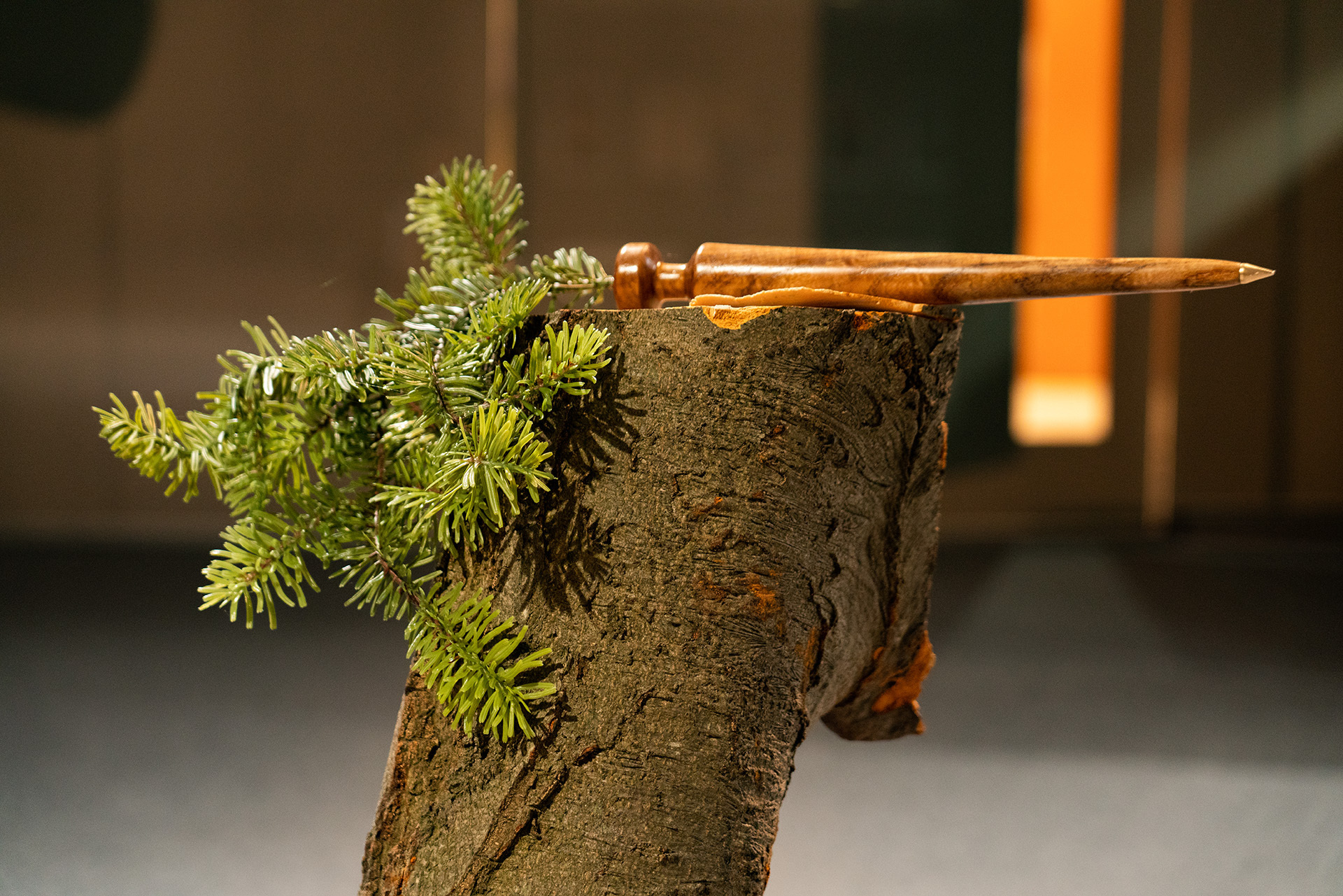 Sacred Sadism, Spiked!, 2021, Mixed media, salvaged elm, zinc alloy, plastic pine bough, poster print, salvaged log Dimensions variable