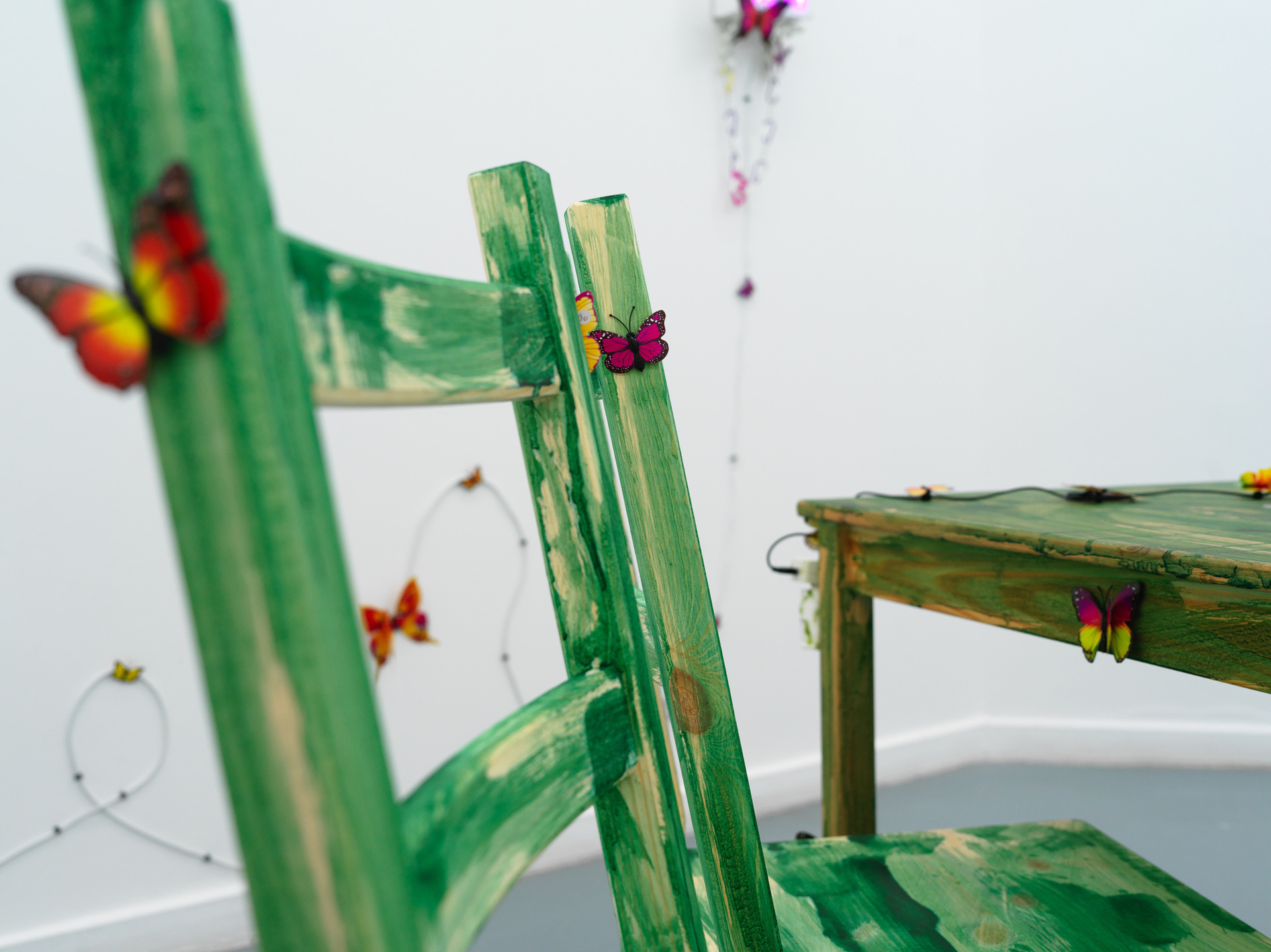 Artist: Theodor Nymark Title: The Mesh Year: 2021 Materials: IKEA IVAR dinner table set with chairs dyed with spirulina, aroma diffuser with Monster Energy Paradise, bluetooth speaker with custom soundtrack, custom box dyed with spirulina for natural wine, custom box dyed with spirulina for IKEA wine glasses, IKEA CYLINDER vases with water pearls and flowers from Aldi.