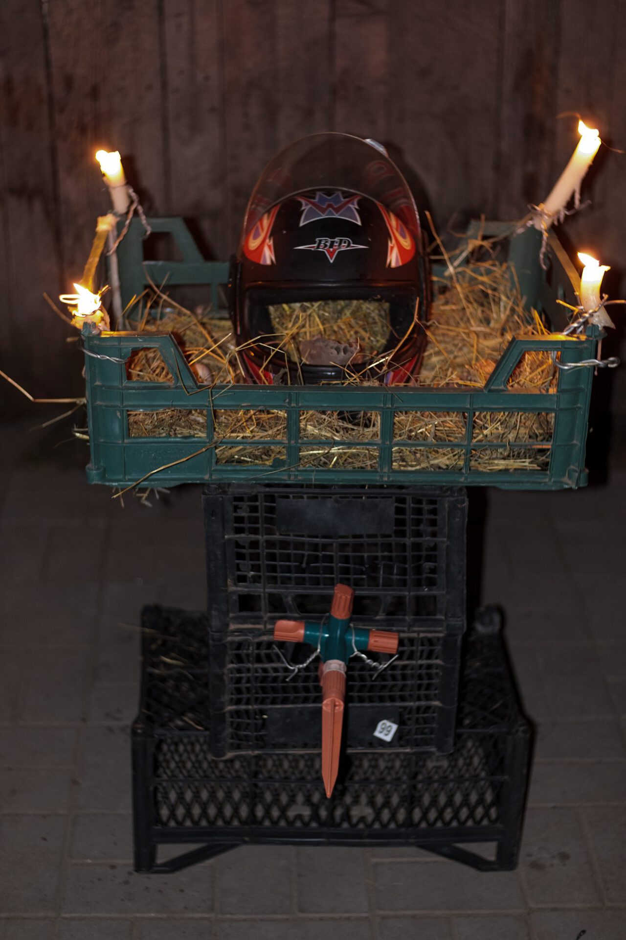 Ritual Object No. 2, 2021, helmet, straw, chicken eggs, candles, plastic baskets, animal jaw