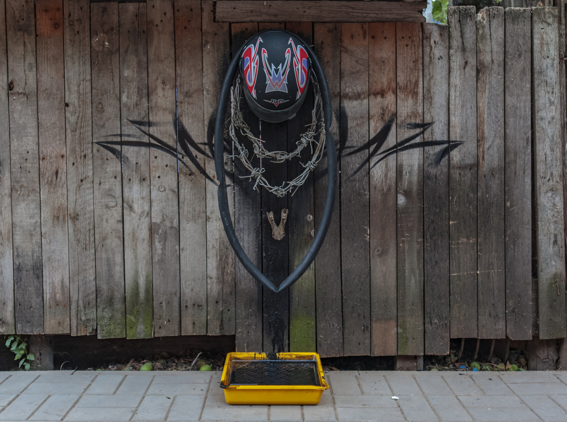 Evgeny Berezin, Ritual Object No. 1, 2021, helmet, tire, wire, animal jaw, tray, playing cards