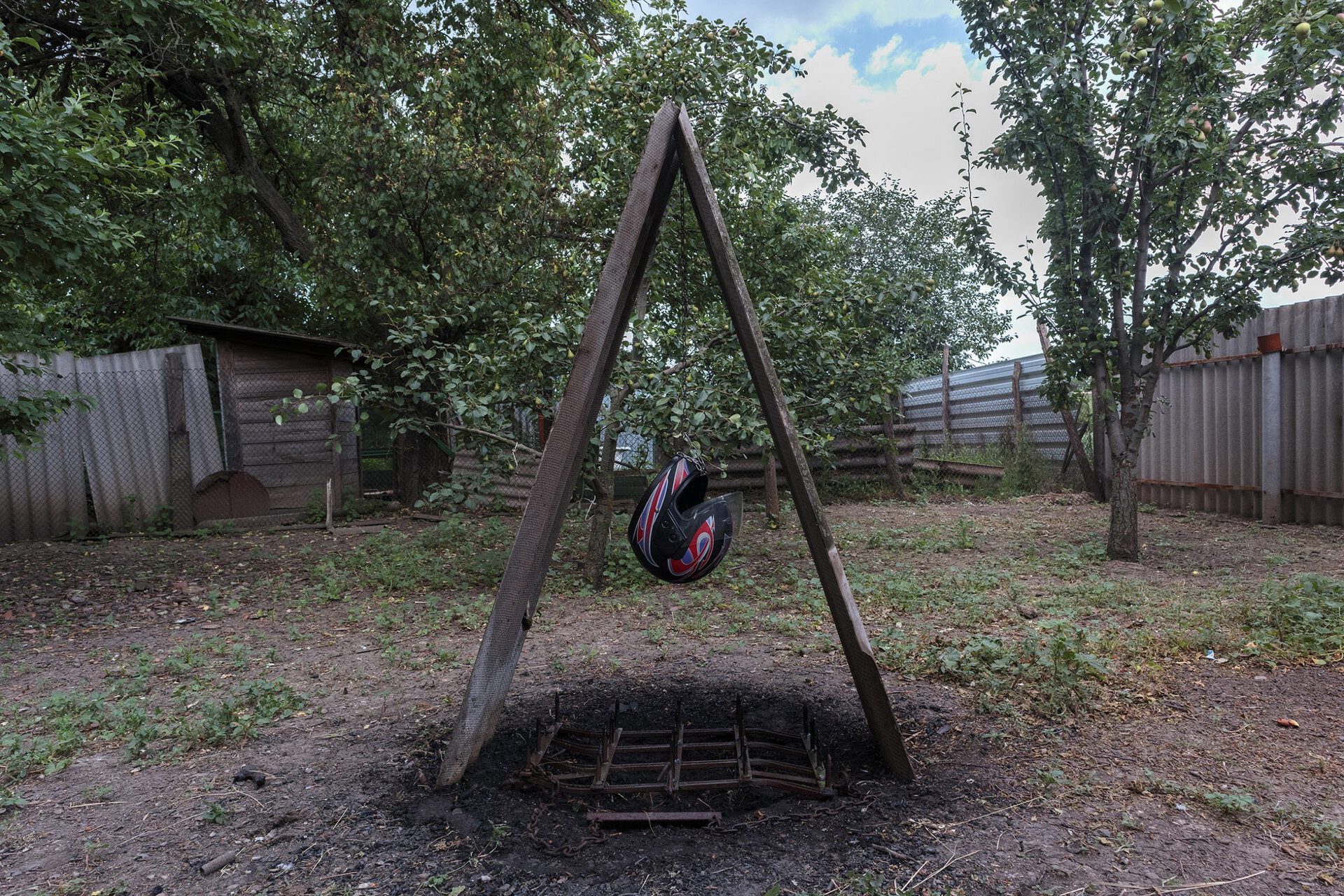 Ritual Object No. 3, 2021, slate, helmet, metal chain, plow, charcoal