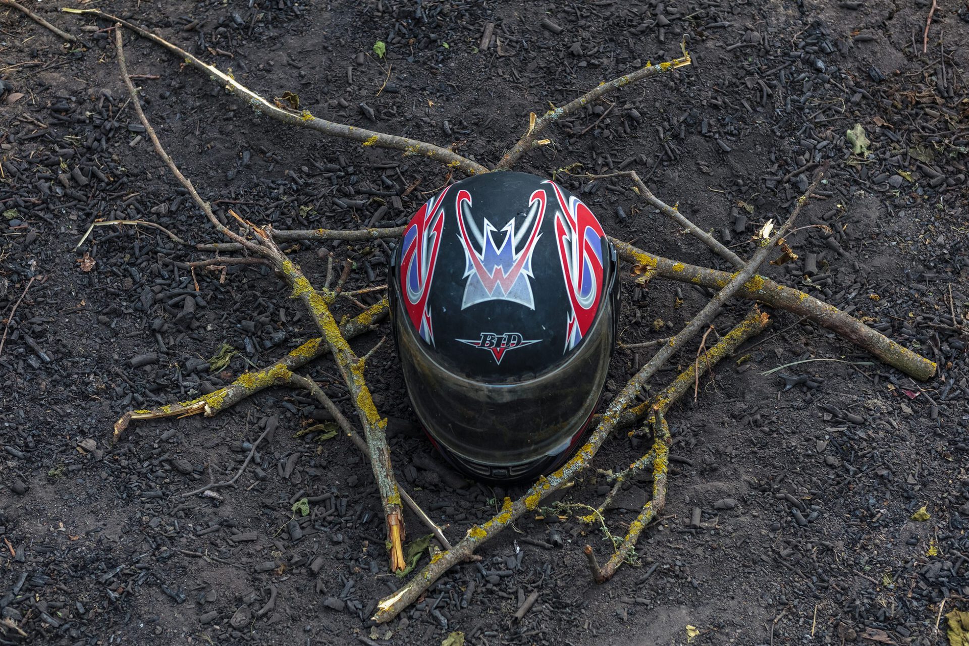 Ritual Object No. 4, 2021, helmet, charcoal, tree branches