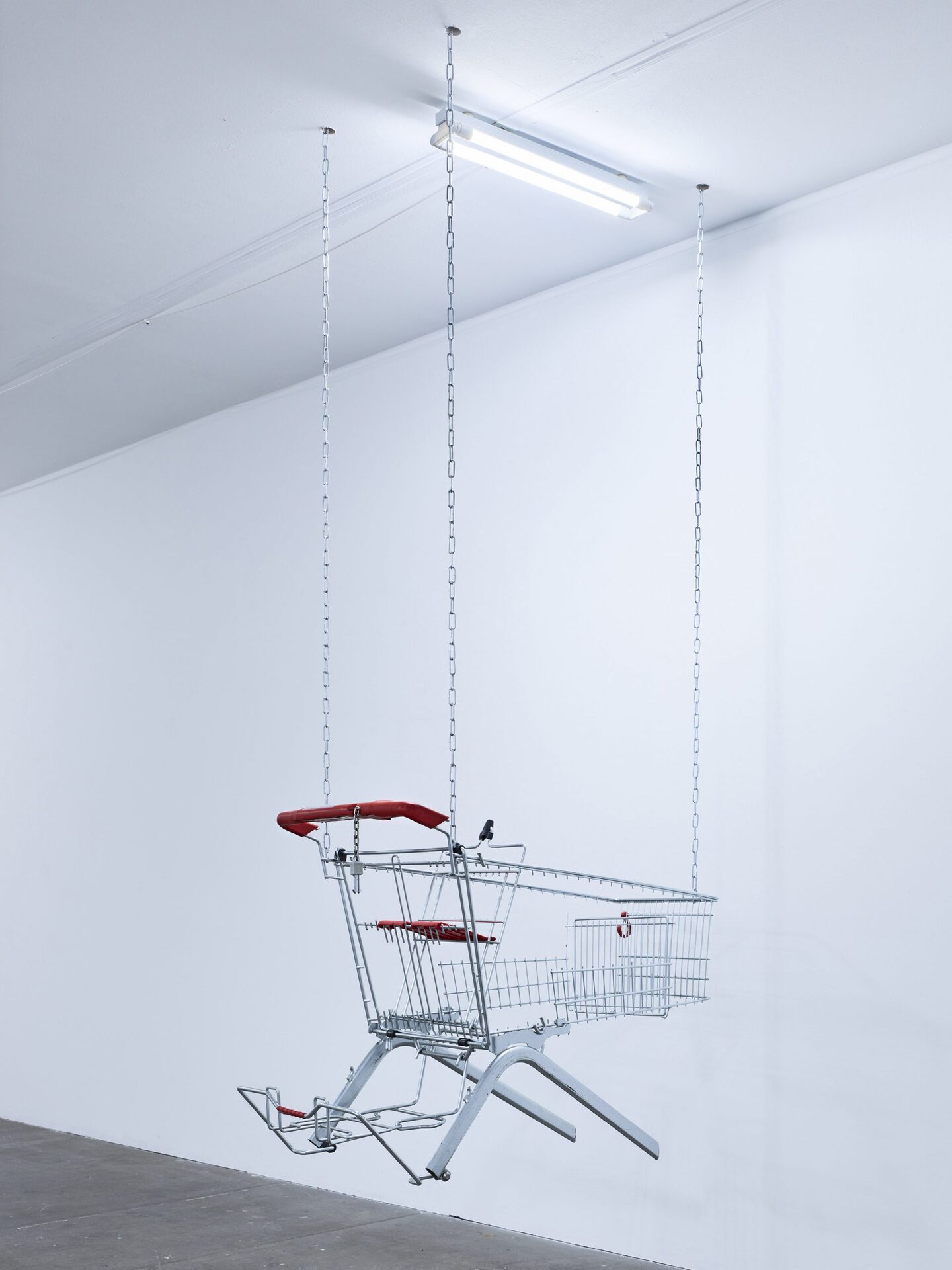 Lars Karl Becker, Tap Water from Coke Bottles, 2021, stainless steel, shopping carts, chains, led fluorescent tube. Photo: Roman Mensing, artdoc.de