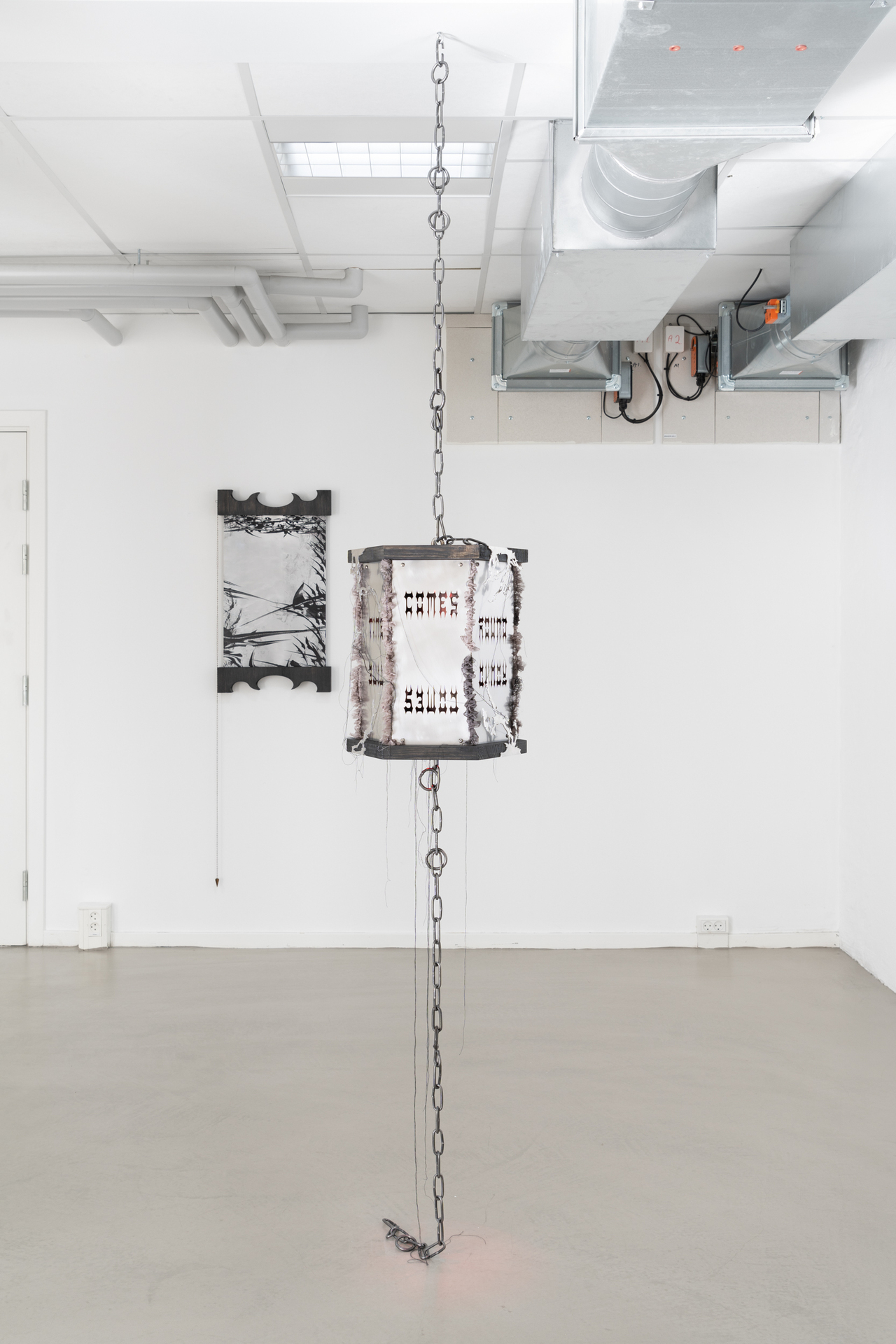 Inside Job (Ula Lucińska & Michał Knychaus), Kerosene (Time comes round), steel, wood, light, silk, aluminium, 2021 & Scoria II, silkscreen on aluminium, wood, pendulum, 2021