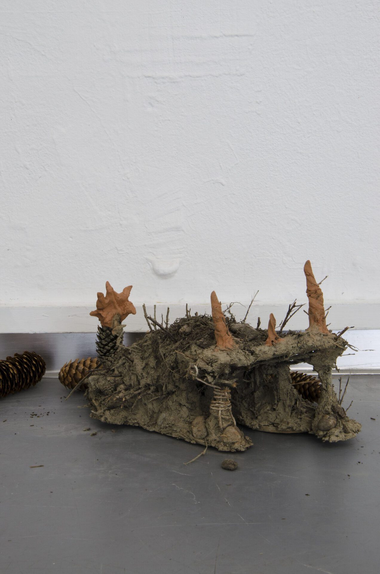 burrows, 2021, polyurethane, paint, dirt, sticks, stones, cones