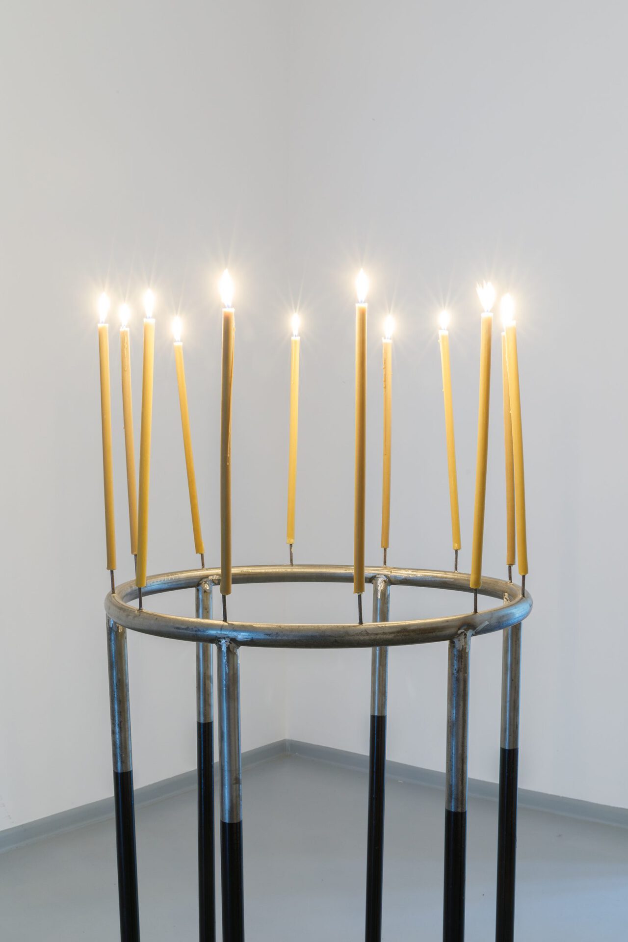 Alexander Beglarishvili To all the male torsos Keti Kapanadze has cut up (twelve branched Candelabra) 110 x 70 cm Sanded steel, metal paint, beeswax candles