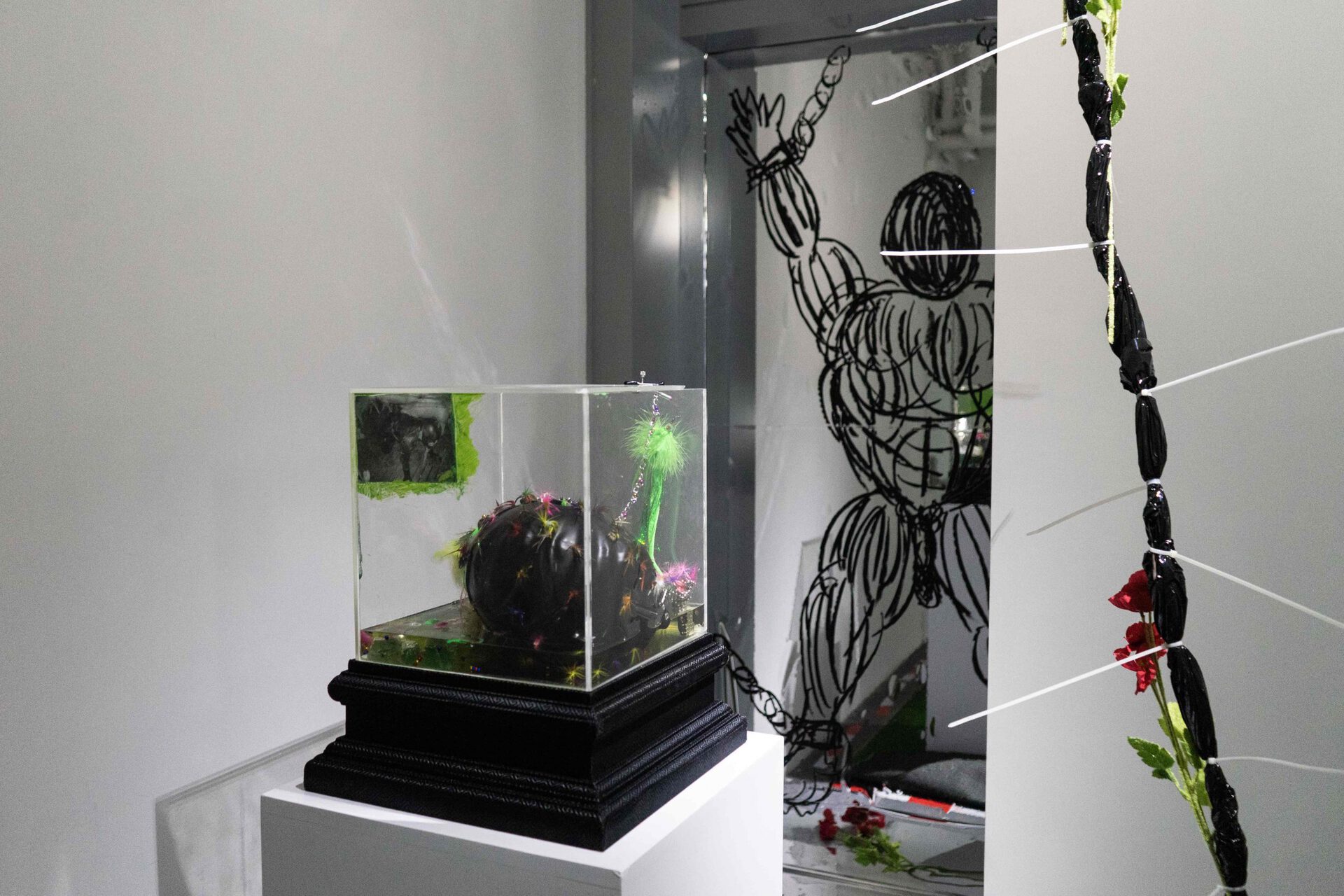 Chen Pin Tao, Gimp 001 (Decapitated), 2020, Acrylic glass, resin, magnets, inkjet print on paper, latex mask, fishing lure, stainless steel chains, crystals, 45 x 38 x 38 cm