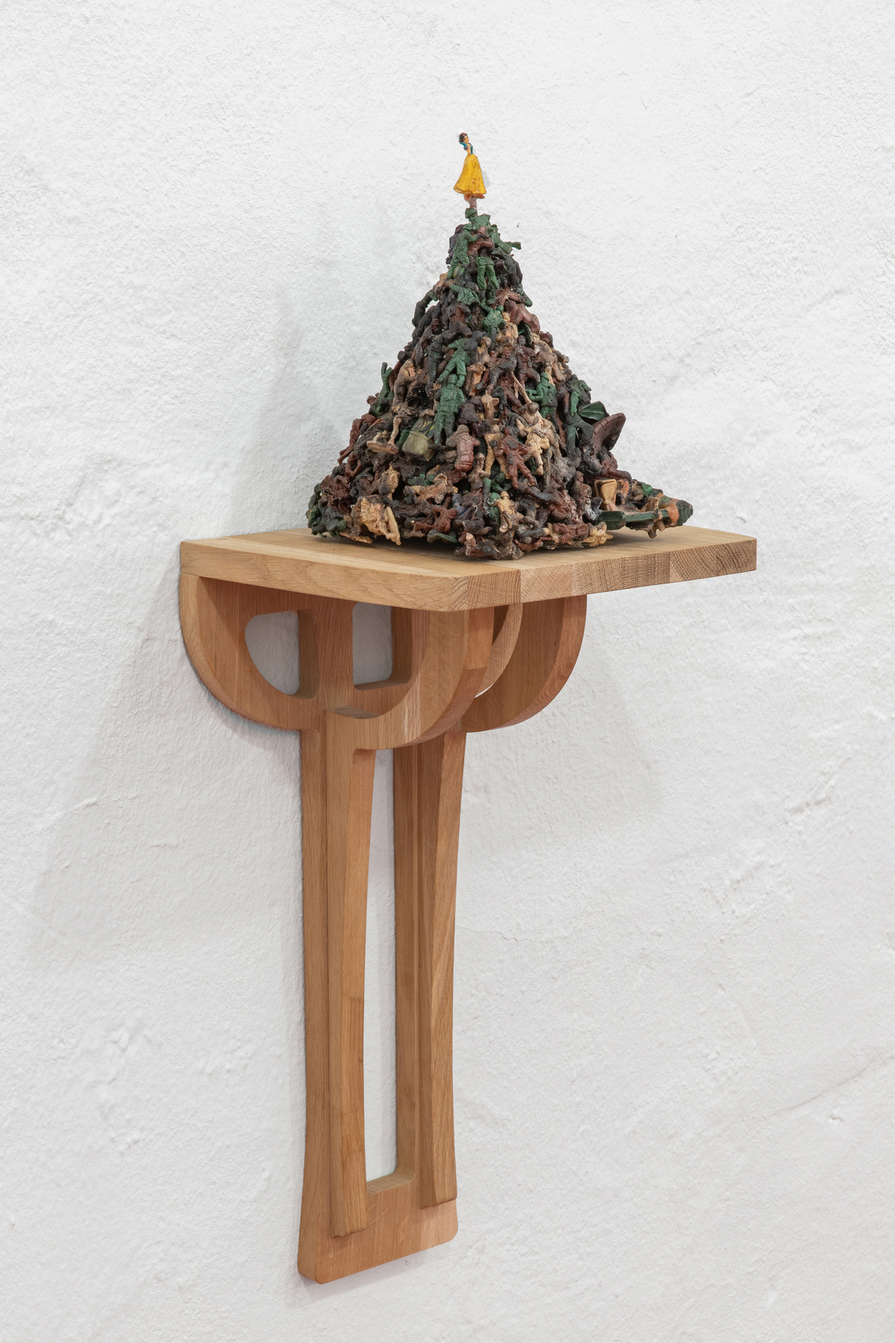 Five Types of Soldiers, 2011, plastic figurines treated with cyanoacrylate and nitrogen enriched gasoline, 17 × 27 × 20 cm on top of handcrafted oak shelf, courtesy of the gallery