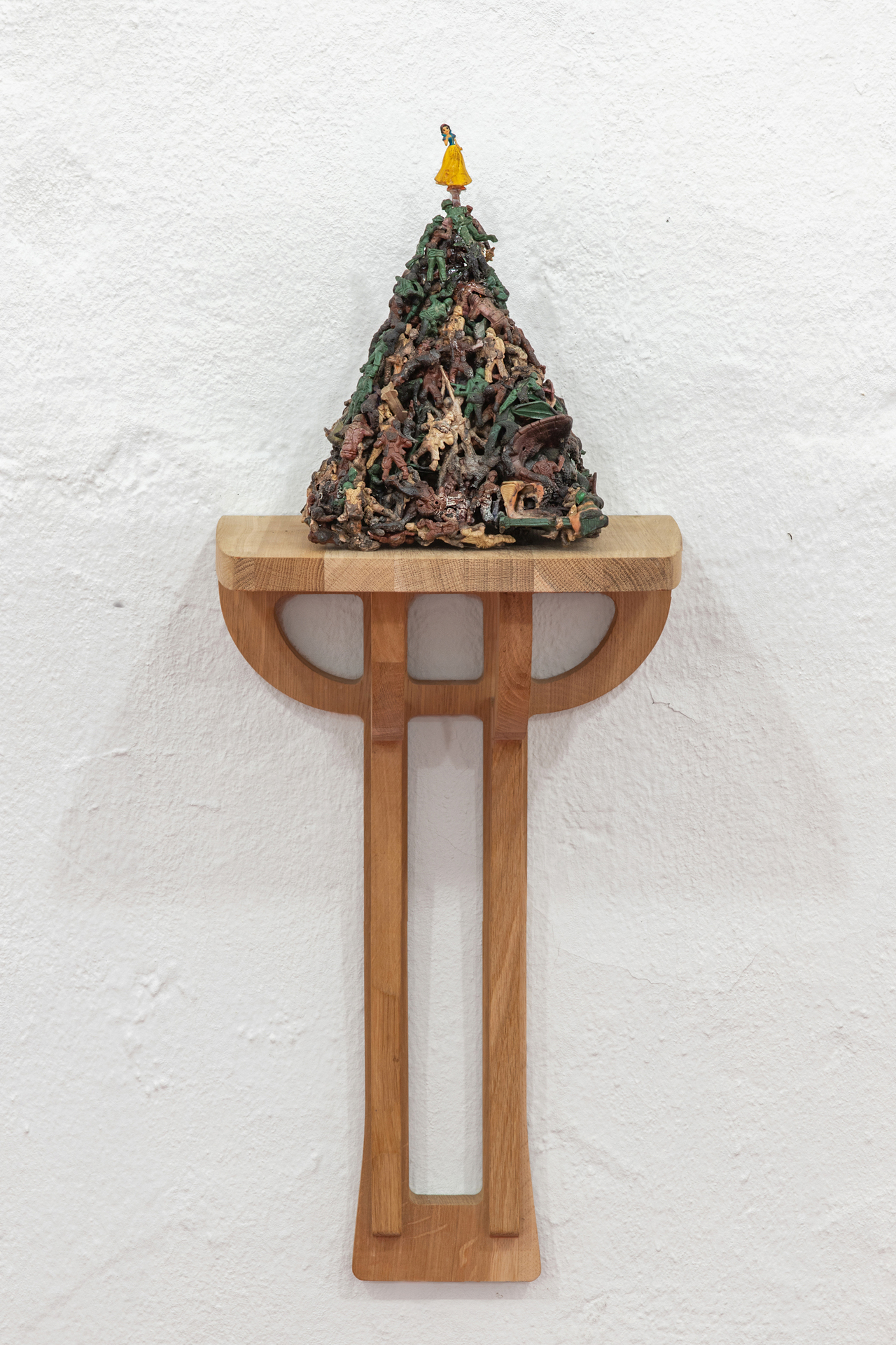 Five Types of Soldiers, 2011, plastic figurines treated with cyanoacrylate and nitrogen enriched gasoline, 17 × 27 × 20 cm on top of handcrafted oak shelf, courtesy of the gallery