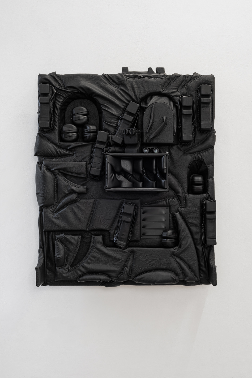 Cezary Poniatowski  Untitled, 2022 Pleather, plywood, upholstery foam, anti-noise earmuffs, staples, binoculars, 125x100x20 cm Courtesy: The Artist