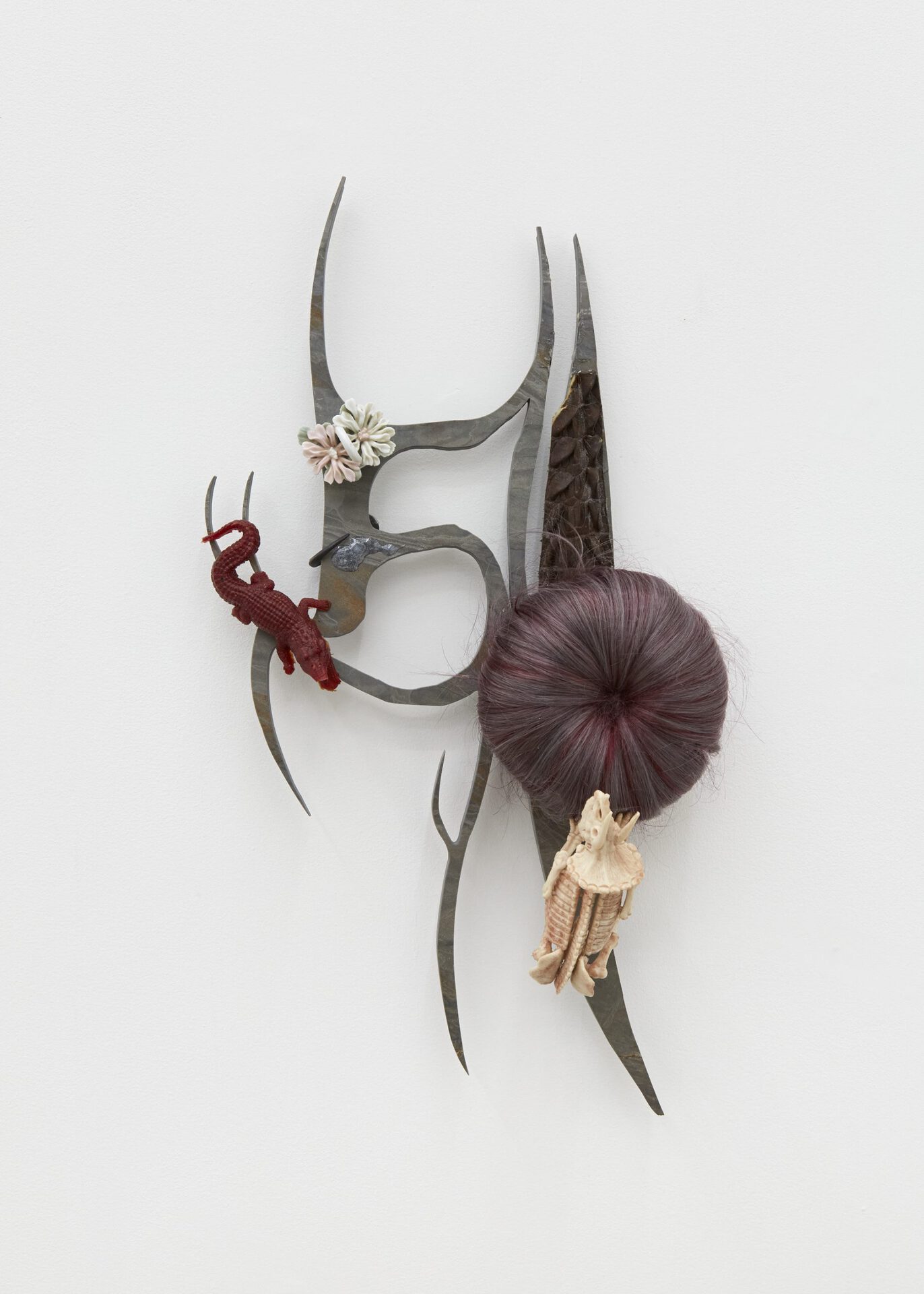 If you want my love try to unlock it, 2022. Epoxy resin, synthetic hair, plastic toys, slate, alligator skin, found porcelain bowl, butchers hooks, slate 60 x 30 x 15 cm