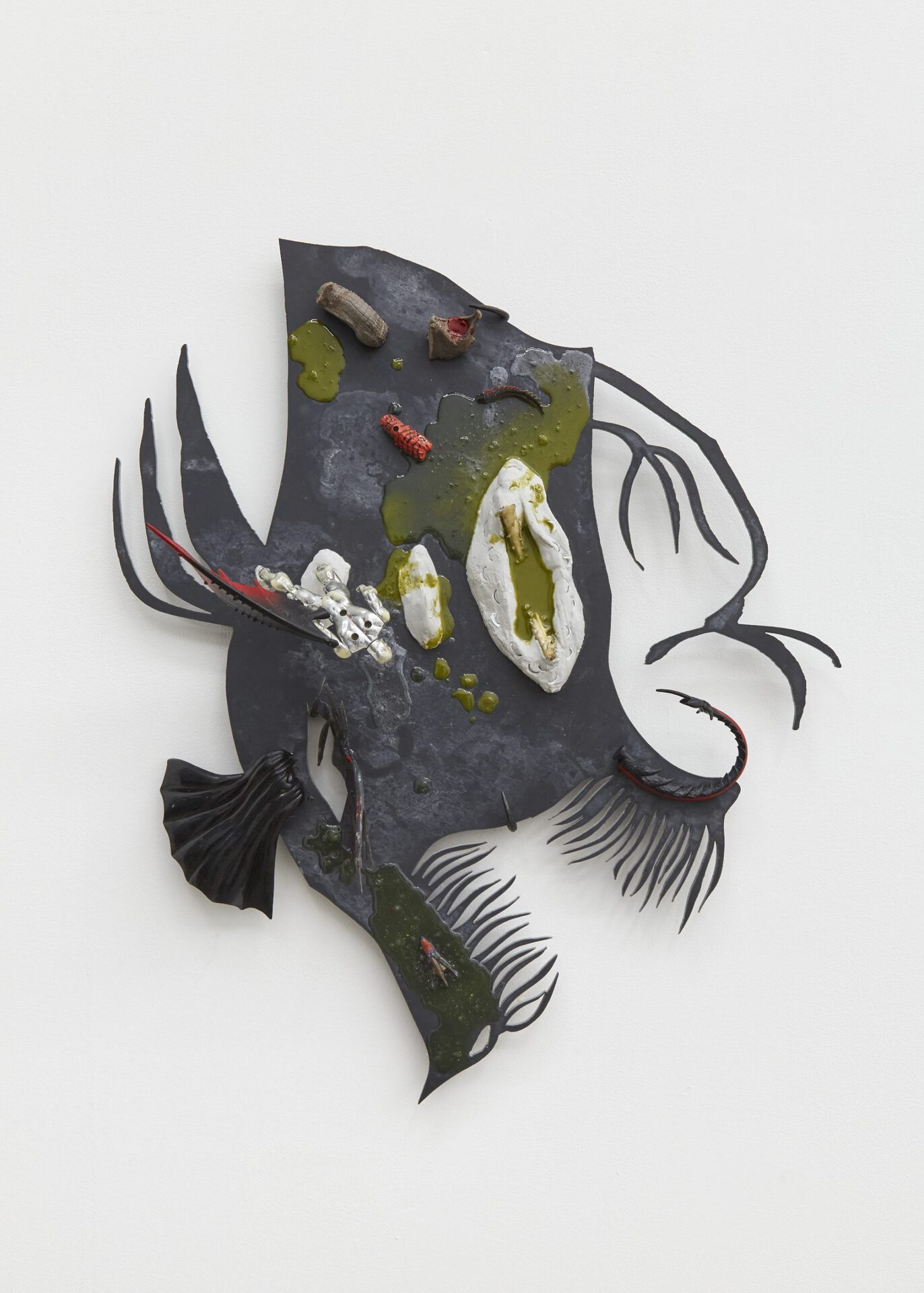 Gonna burn down like fire, 2021-2022. Epoxy resin, epoxy putty, plastic toys, eel jaw, fake nails, toy figurine, found plastic wing, prosthetic silicon, Roussillon pigments, butchers hooks, slate, 64 (L) x 55 (W) x 13 (L) cm