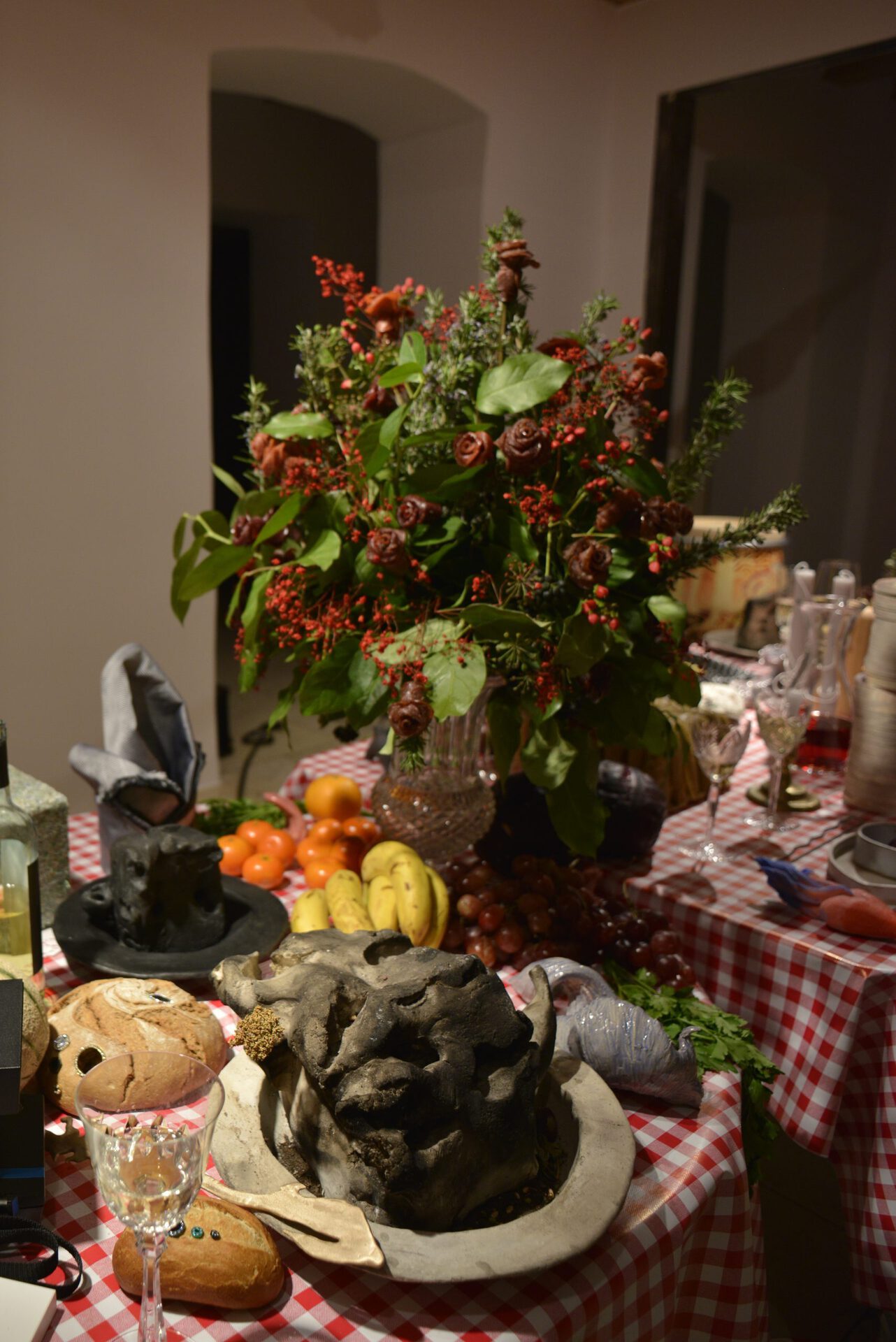 Installation Shot, Ceramics: Kristina Lovaas,A Gourmand's Delight, 2022 Raku fired ceramics, dirt, dried flowers, food scraps, seeds, wax 30 x 48 x 48 cm ; Flower Bouquet: Marie Jaksch, 2022, Flowers + Salami, 80 x 50/60 cm, Bread: Johannes Büttner,Bauernbrot , 2022 Bauernbrot, flesh tunnels